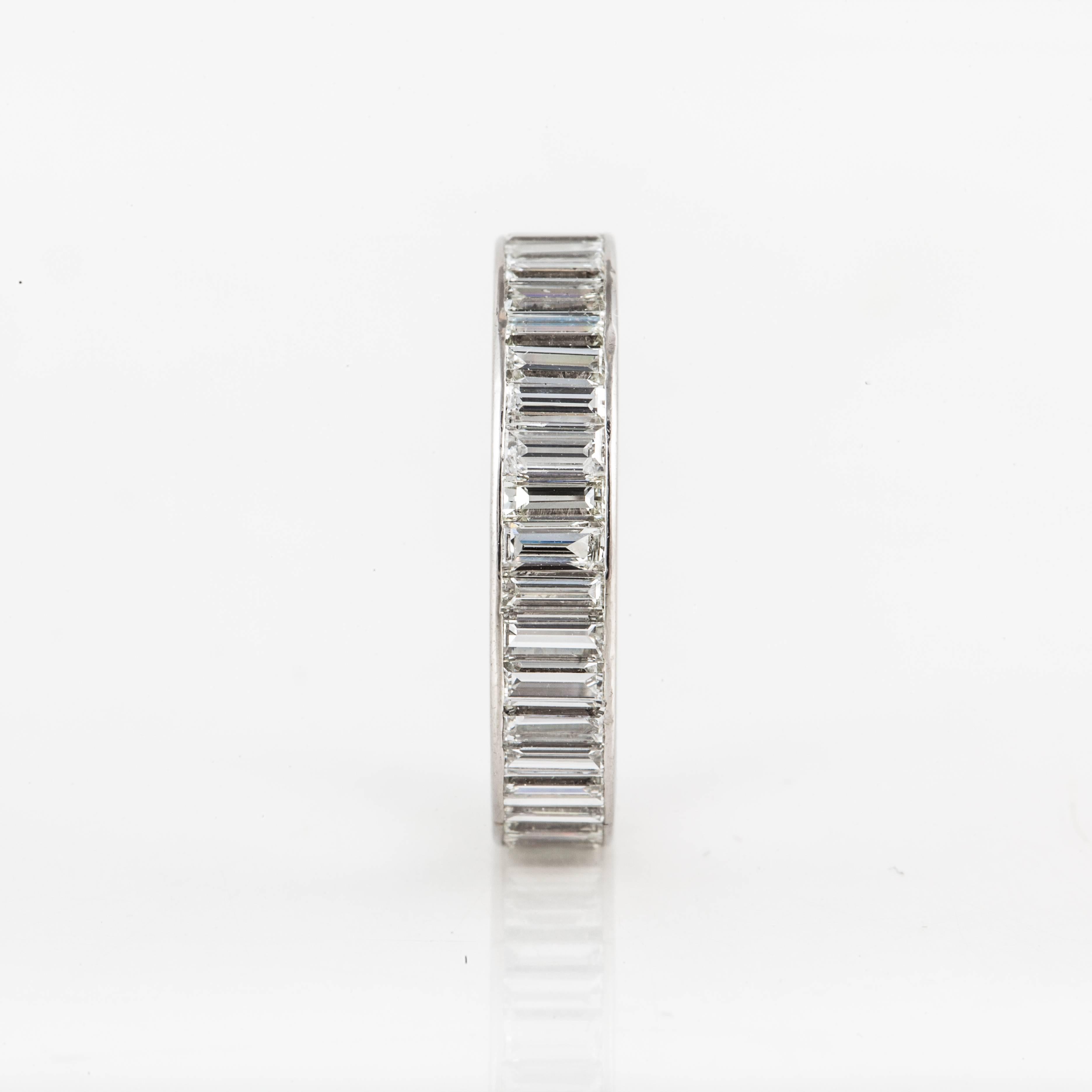 Van Cleef & Arpels eternity band featuring baguette diamonds in platinum.  It is marked around the outer edge 