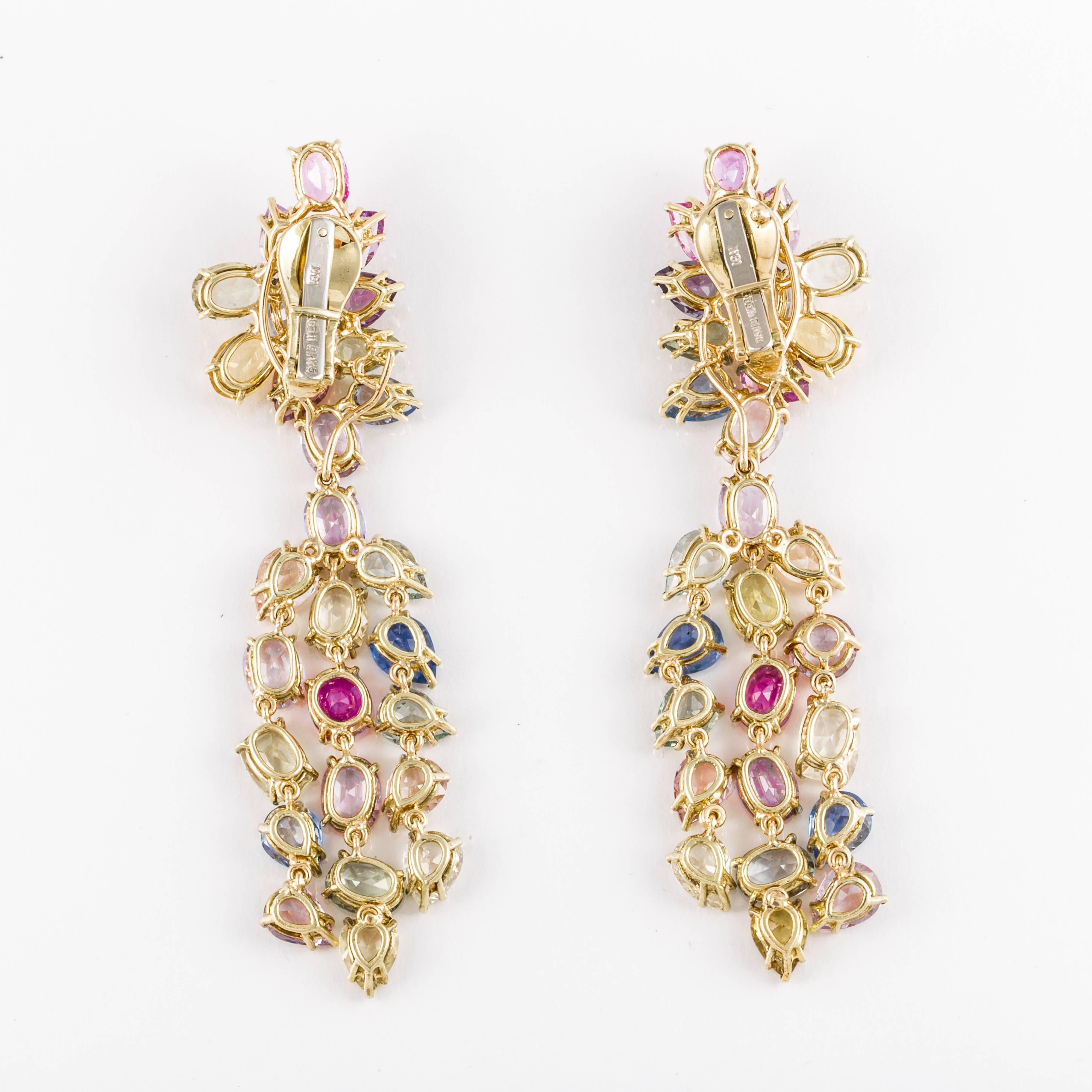 David Webb cluster day/night earrings featuring multi-colored sapphires that total approximately 70 carats.  Earrings are marked 