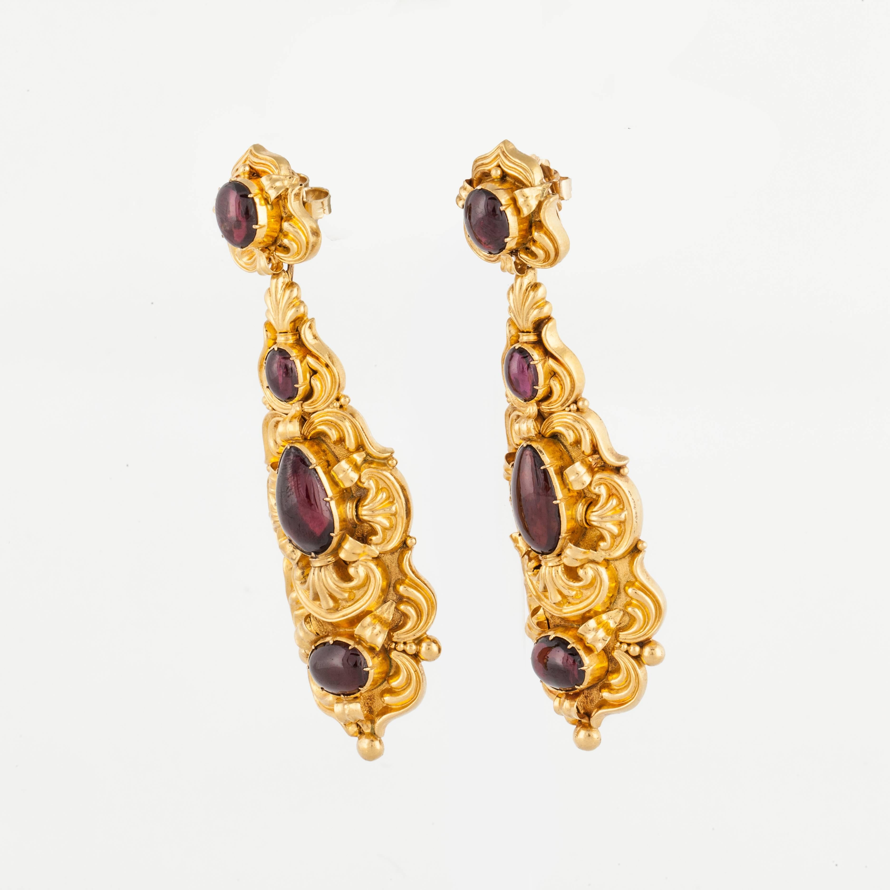 Georgian earrings composed of 18K yellow gold and cabochon garnets.  The garnets are foil backed and the earrings should not be submersed in liquid.  They measure 3 1/8 inches long and 1 inch wide at the bottom.  They are for pierced ears with a