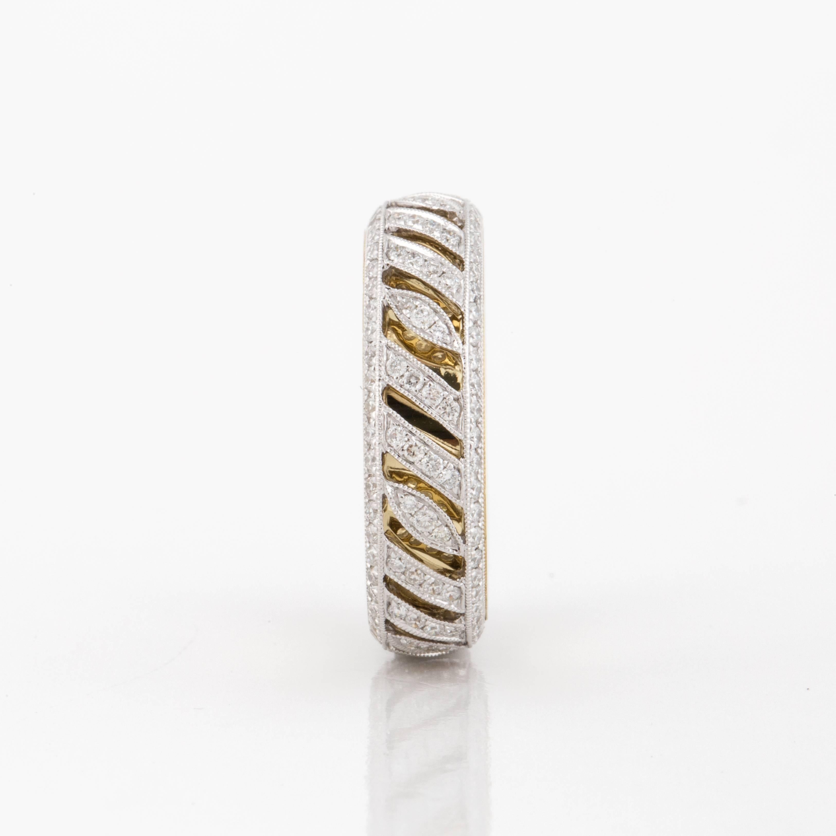 Band composed of 18K two-tone gold with diamonds.  Ring is marked 