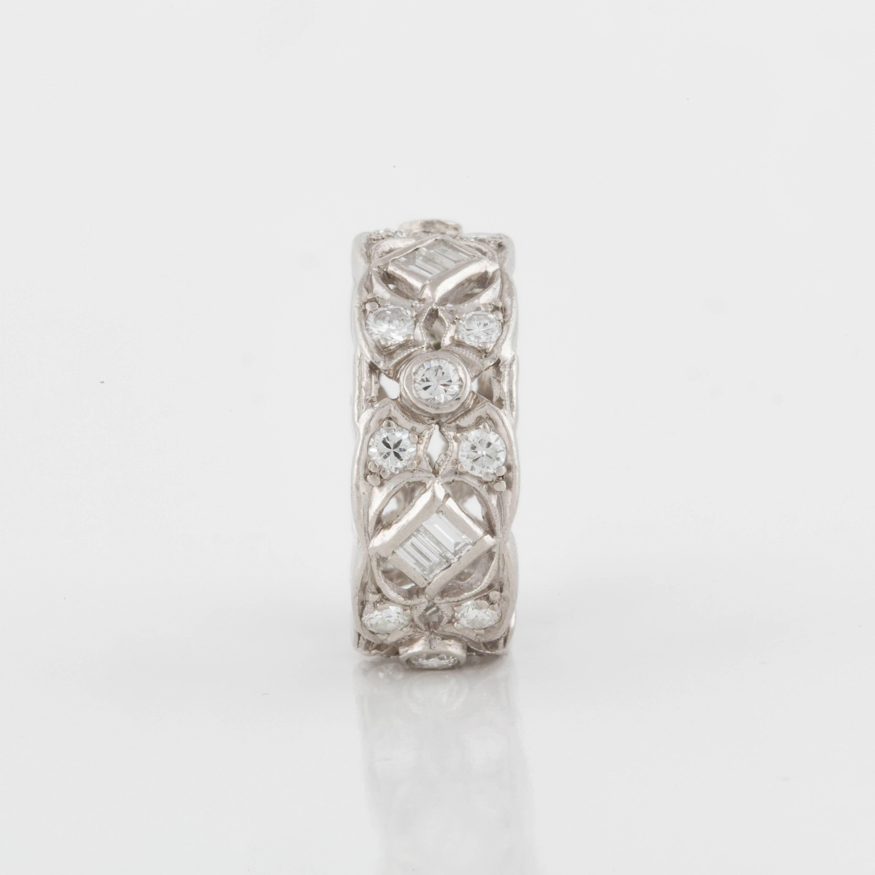 Platinum openwork diamond eternity band featuring baguette and round diamonds.  There are eight baguettes and twenty round diamonds totaling 1.65 carats.  Measures 5/16 inches wide and is a size 8 1/2.
