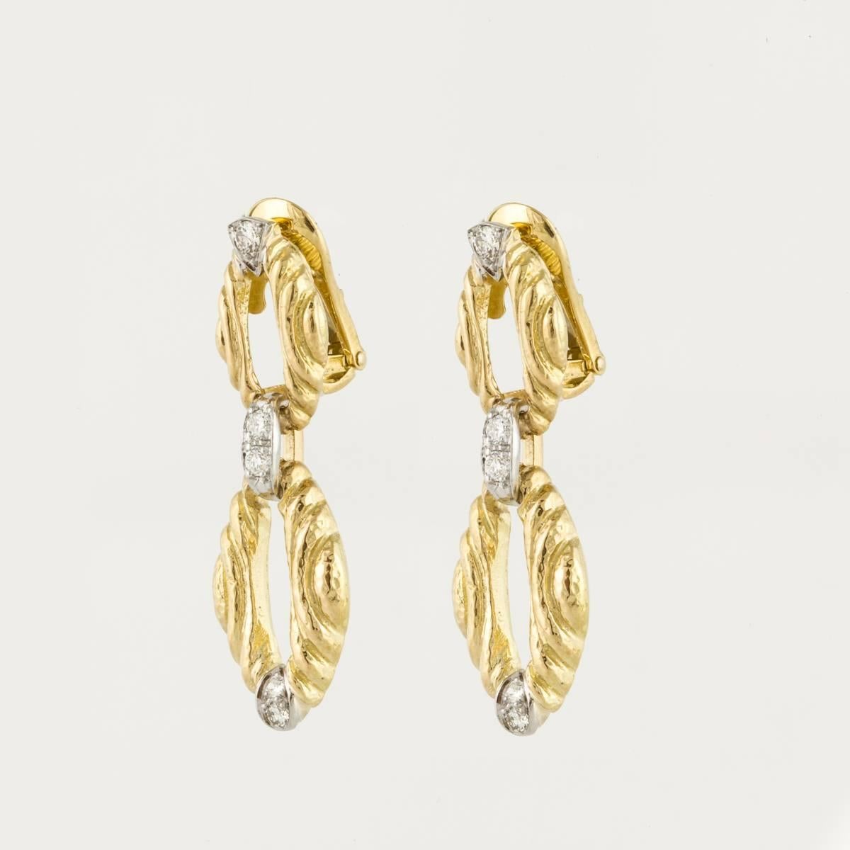 These David Webb earrings are 18K yellow gold with diamond accents.  The earrings are marked 