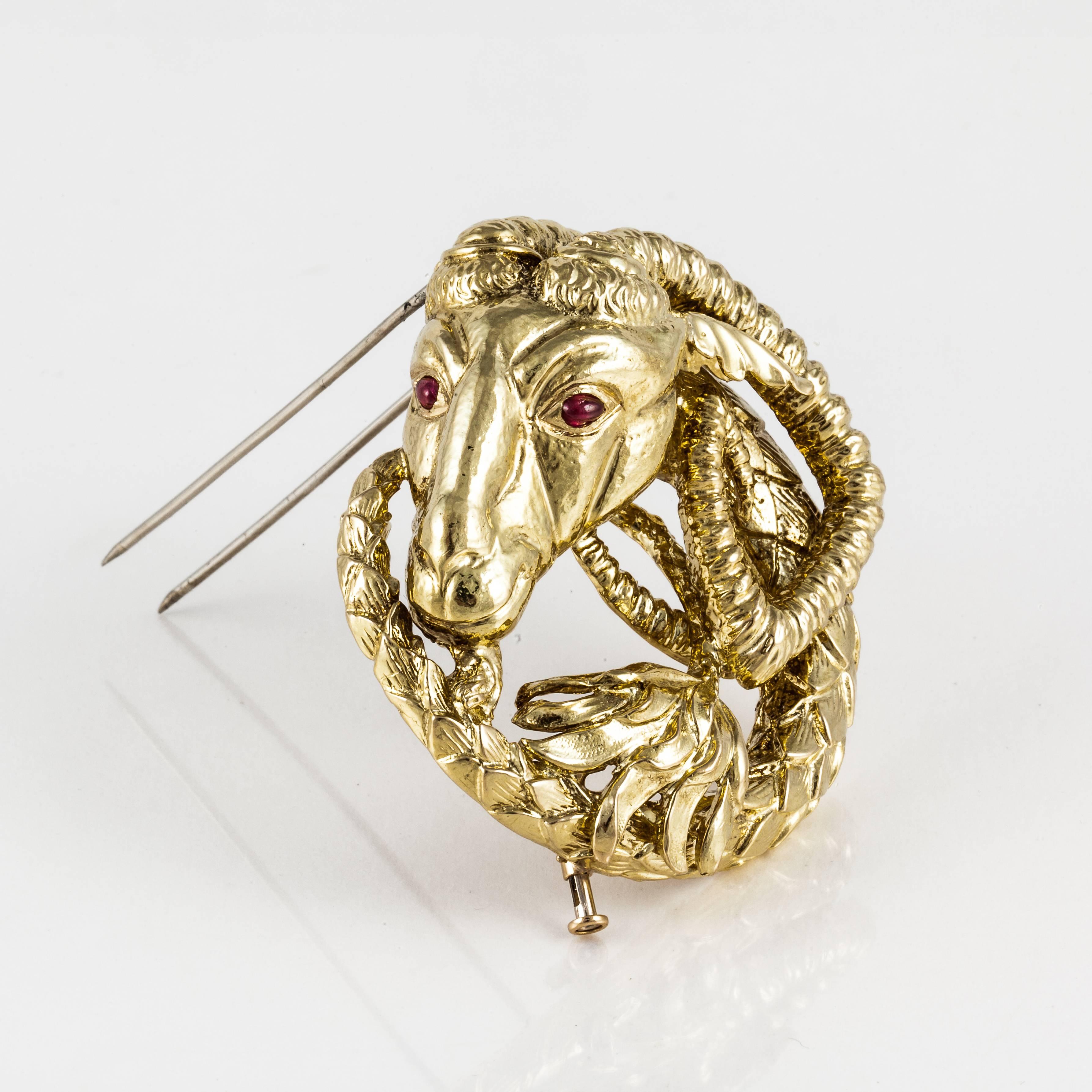 David Webb ram's head brooch in 18K yellow gold with cabochon ruby eyes.  Marked on the back 