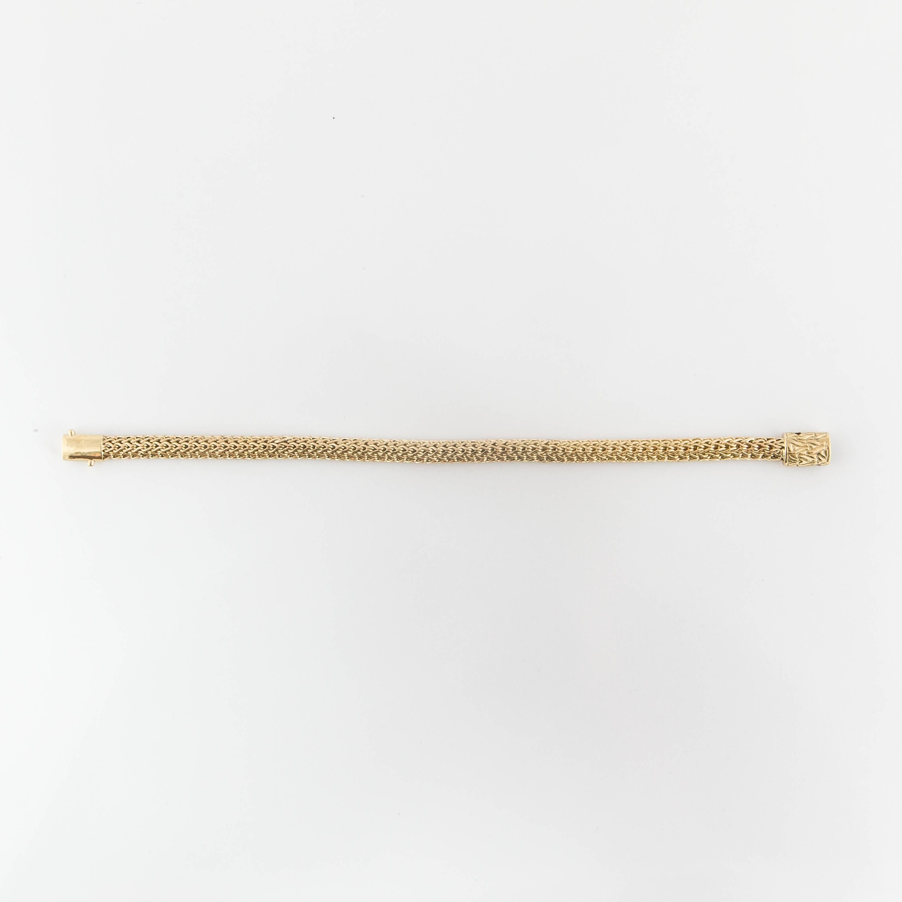 This classic bracelet by John Hardy is 18K yellow gold and marked 