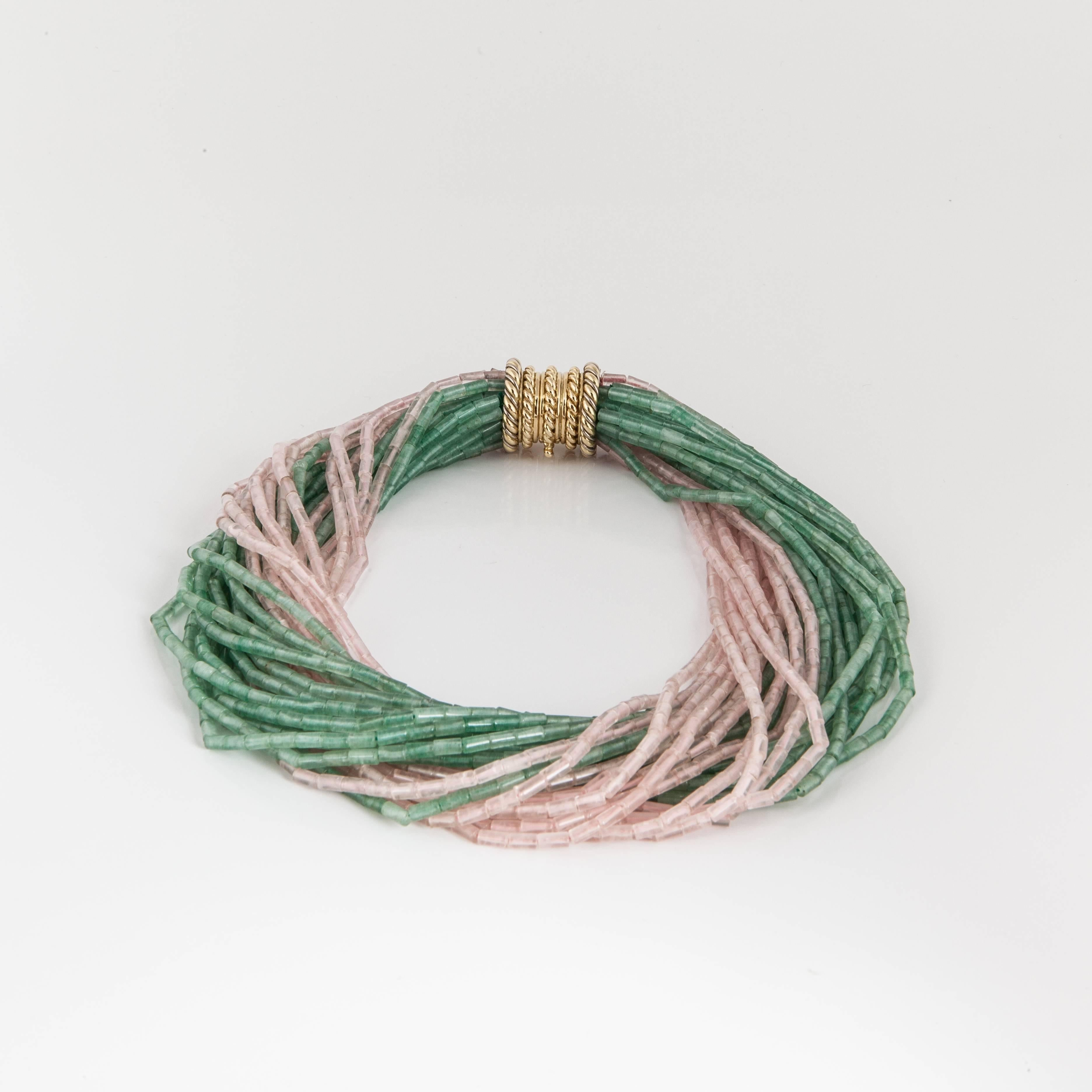 Tiffany & Co. tornado necklace featuring multiple strands of green and pink quartz beads forming a twisted necklace.  The 18K yellow gold clasp has a rope design and is inscribed on the inside 
