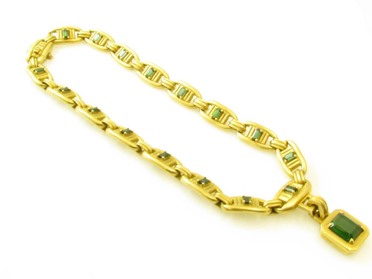 An 18 karat yellow gold and green tourmaline “Colonnade” necklace with detachable gold and green tourmaline pendant, signed Kieselstein Cord 1976 18K.  The necklace and pendant have a gross weight of approximately 150.0 grams.  The necklace measures