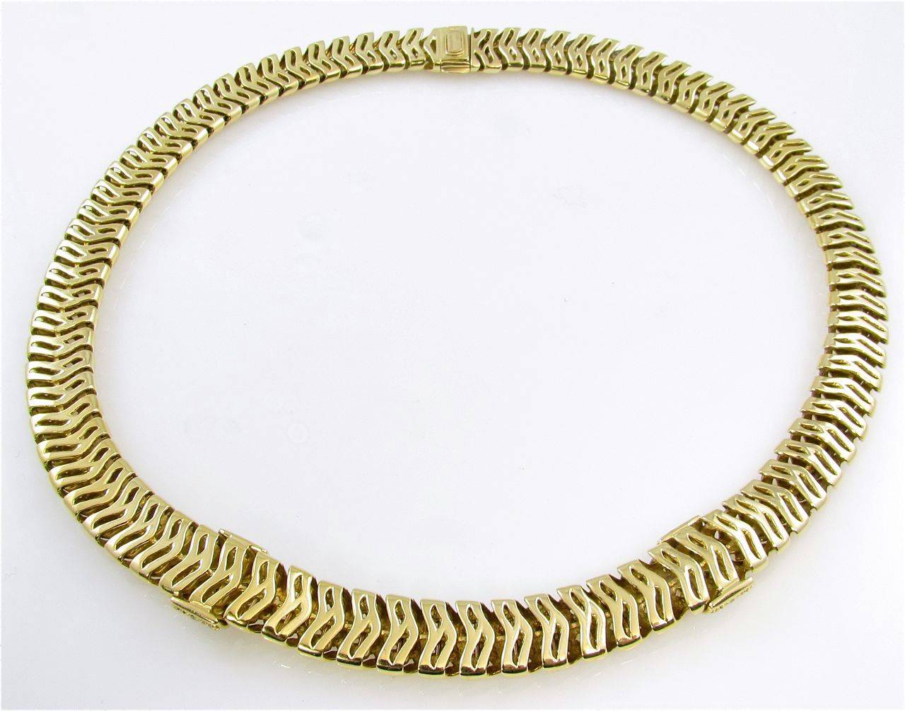 An 18 karat yellow gold and diamond “Vannerie” necklace by Tiffany & Co., dated 1995.  The choker length necklace is of openwork woven gold design measuring 1/2 inch wide, the front section is set with 2 round brilliant cut pave diamond sections,