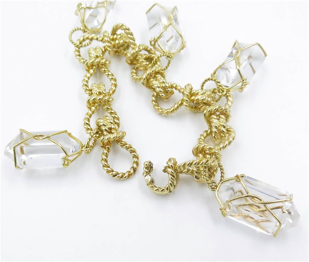 An 18 karat yellow gold and rock crystal Herkimer bracelet, Verdura. Designed as a ropework link bracelet, suspending five (5) fancy-cut rock crystal pendants, each wrapped in gold wire. Length of bracelet is 8 inches. Gross weight is approximately
