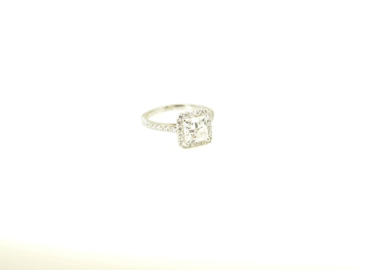 A platinum and diamond ring.  Centering a princess-cut diamond of 1.52 carats, with Tiffany & Co. appraisal stating H, VVS1.   GIA has issued Diamond Grading Report 2155746588, dated November 06, 2013, stating:  Shape and Cutting Style Square