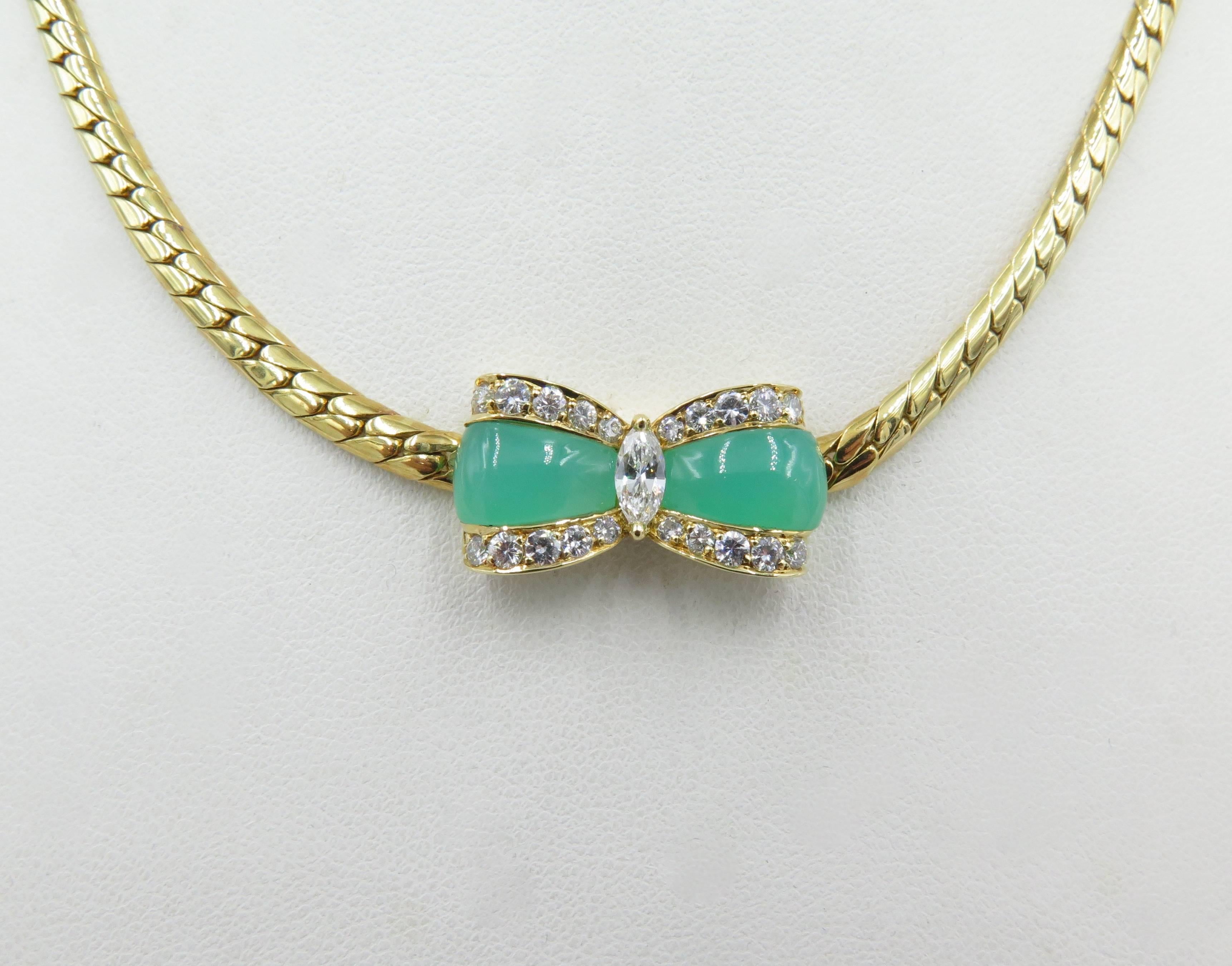 An 18 karat yellow gold, chrysoprase and diamond necklace. Van Cleef and Arpels. French. Designed as a flat link chain, centering a chrysoprase bow, with circular diamond trim, centering a marquise cut diamonds. Twenty (20) circular-cut diamonds
