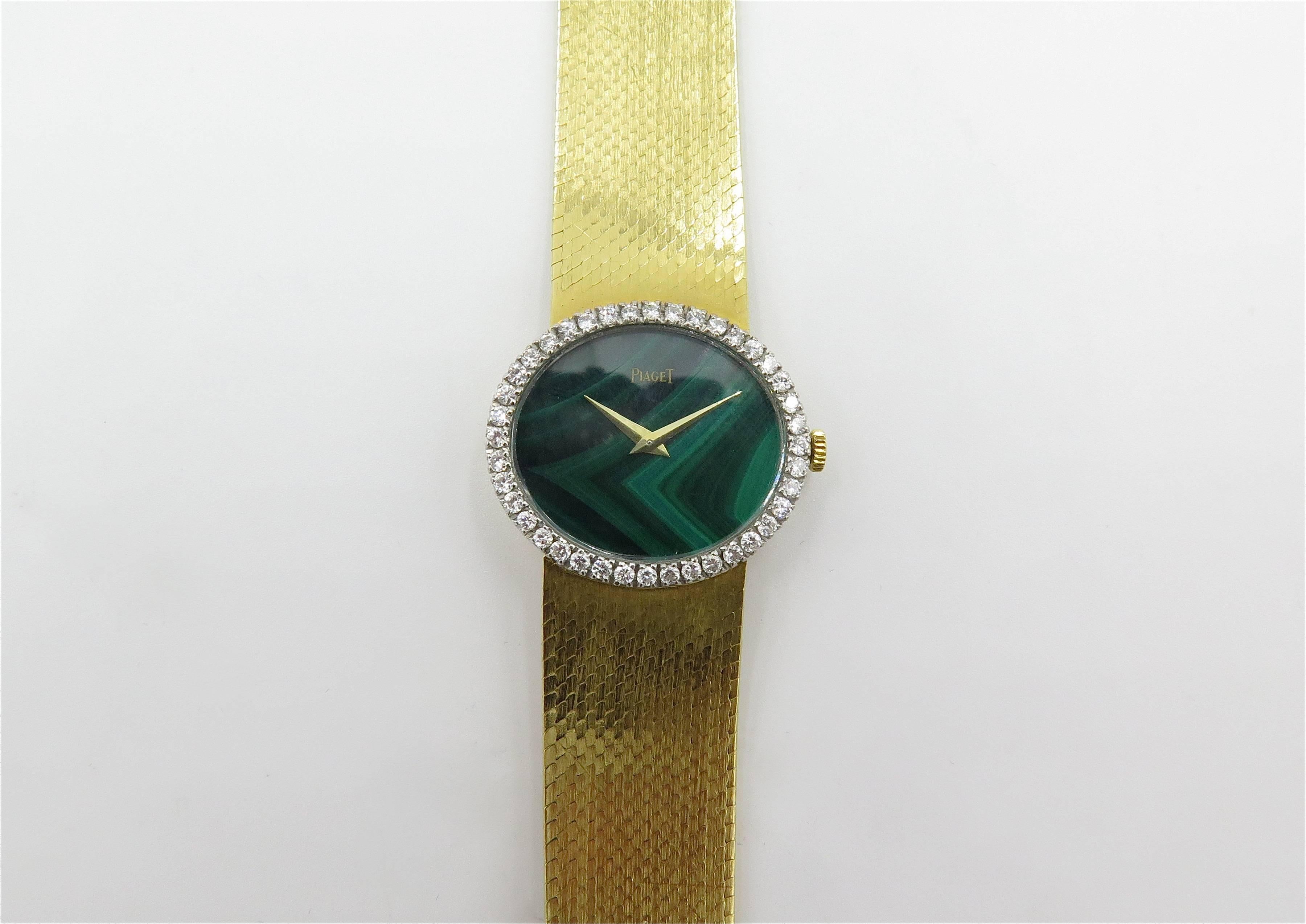 An 18 karat yellow gold, malachite and diamond watch. Piaget. Circa 1970. Of mechanical movement. The oval malachite dial with gold hands, within a circular cut diamond bezel, joined by a Gold bracelet. Forty (40) diamonds weigh approximately 1.00