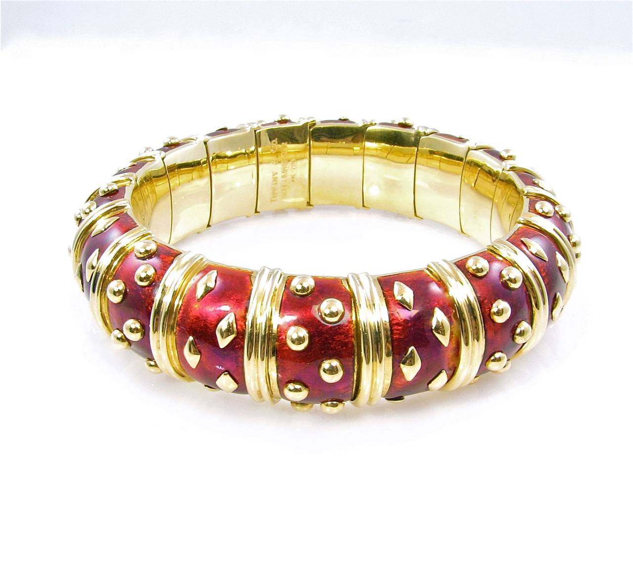 An 18 karat yellow gold and red paillonné enamel 