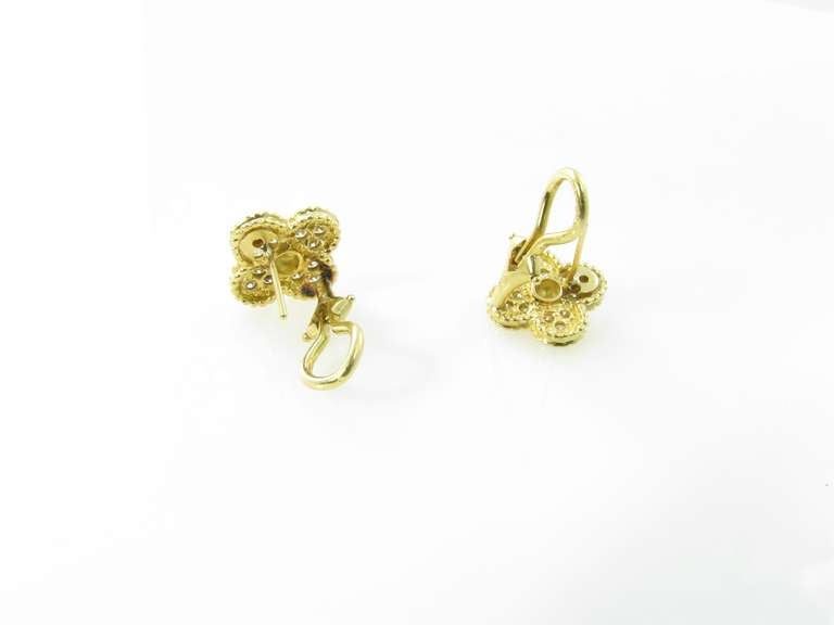 A pair of Van Cleef and Arpels 18 karat yellow gold and diamond “Vintage Alhambra”  earrings.  Circa 1990s.  Signed VCA N.Y. 3K45-70.  The earrings are each set with 12 round brilliant cut diamonds.  The 24 diamonds in total weigh approximately .38