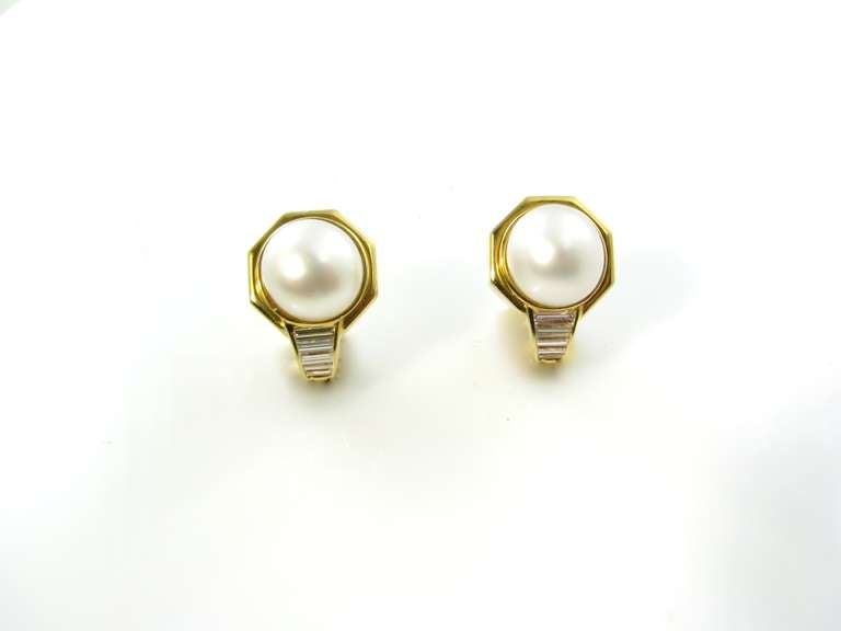 A pair of 18 karat yellow gold, South Sea pearl and diamond earrings, Bulgari, Circa 1980s.  Signed Bulgari .750 C1728.  The earrings are each designed with a South Sea pearl measuring approximately 11.5 mm in a heavy gold octagonal shaped mount,