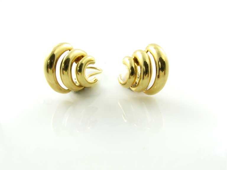 A pair of 18 karat yellow gold earrings, Seaman Schepps, circa 1990.  Signed © 750 Seaman Schepps 12177.  The earrings are designed as 3 graduated curved sections.  The earrings have a gross weight of approximately 15.1 grams and measure 3/4 inch