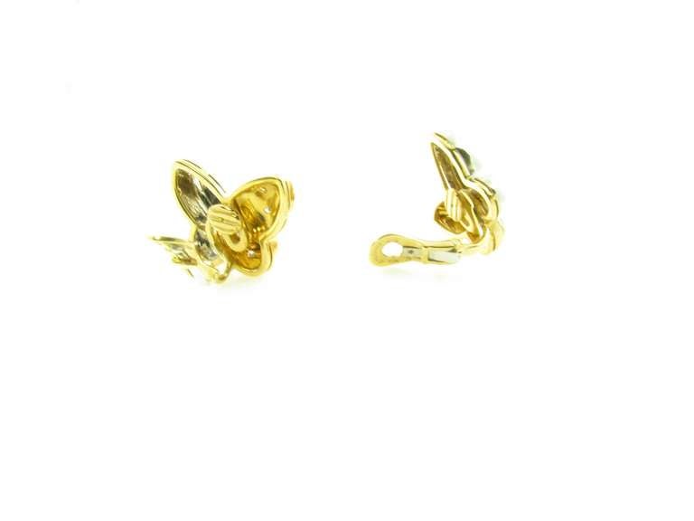 A pair of 18 karat yellow and white gold and diamond “butterfly” form earrings, Bulgari, Circa 2000.  Signed BVLGARI 750.  The butterfly form earrings are designed with one white gold wing and one yellow gold wing.  Each of the yellow gold sections