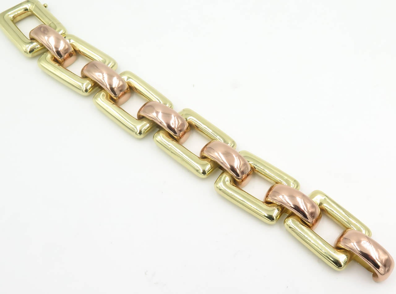 A 14 karat yellow and rose gold bracelet, Tiffany & Co., Circa 1940s.  The bracelet is designed as rectangular yellow gold links alternating with convex rose gold links.  The bracelet has a gross weight of approximately 56.9 grams and measures 8