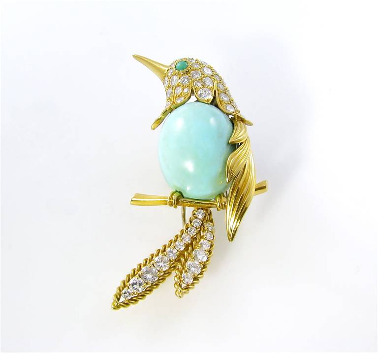 A Van Cleef and Arpels 18 karat yellow gold, turquoise and diamond bird brooch.  Circa 1964.  Signed VCA  © 1965 NY35778.  The bird is designed with a cabochon turquoise body, a pave round brilliant cut diamond set head with cabochon turquoise eye,
