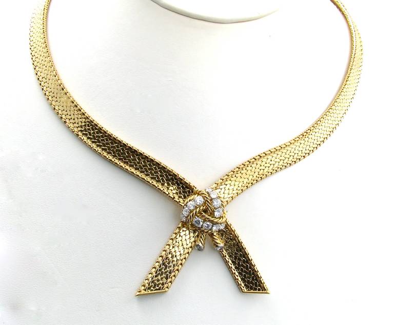 A French 18 karat yellow gold, diamond and platinum necklace by Mauboussin, Circa 1960.  Signed Mauboussin Paris 16138 and hallmarked with French maker’s mark AR in a lozenge, and platinum and gold marks.  The necklace is in a flexible crossover
