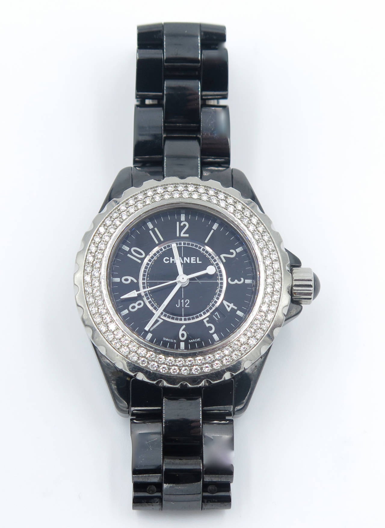 A stainless steel and black ceramic J12 watch by Chanel.  The black ceramic watch features a stainless steel bezel set with 118 round brilliant cut diamonds weighing approximately 1.60 carats.  Quartz movement, Swiss made with numbers Z.M. 23549.  