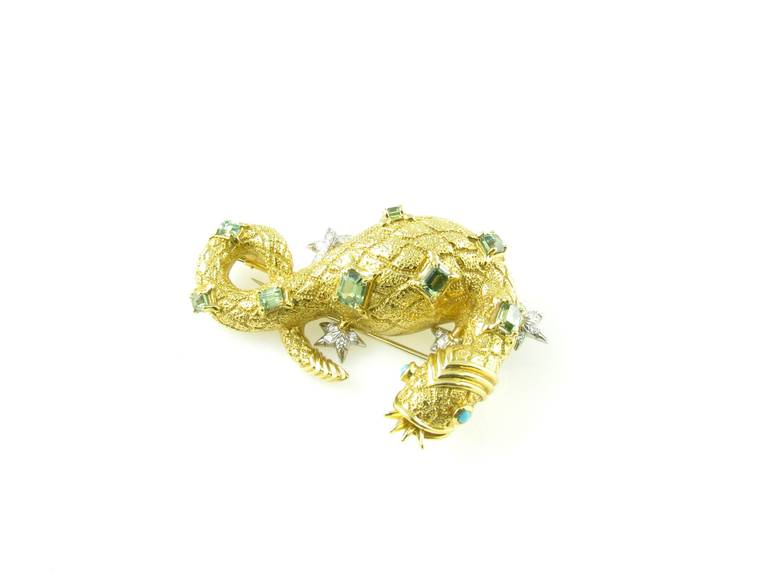 An 18 karat yellow gold, platinum, green tourmaline, diamond and turquoise Salamander brooch by Schlumberger, Tiffany & Co., circa 1990s.  Signed Tiffany & Co. 750 Schlumberger.  The gold salamander is of textured gold with pave round brilliant cut