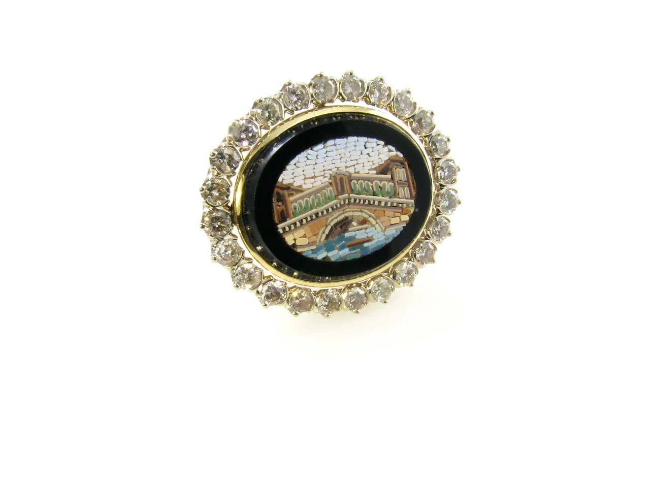 An antique micromosaic depicting the Rialto Bridge in a contemporary 18 karat white and yellow gold and diamond cluster mounting.  The micromosaic is 19th century, the mounting is designed by Marcella Ciceri.  The cluster mount contains a total of