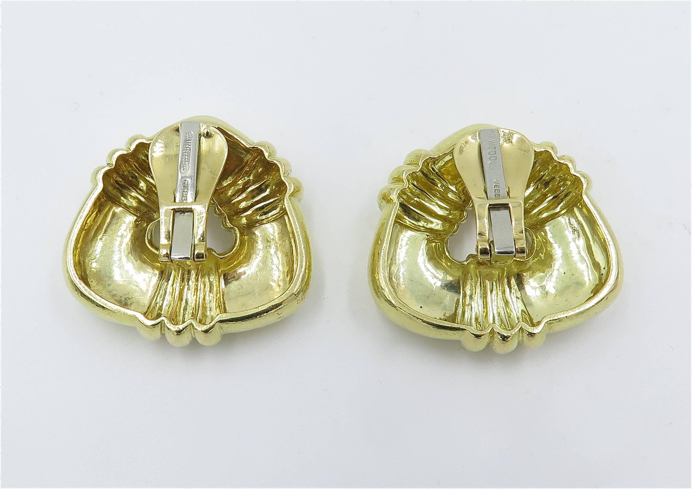 A pair of 18 karat yellow gold hand hammered triangular shaped earrings, David Webb, Circa 1970s.  Signed © Webb ® Webb 18K.  The earrings are each set with 3 fluted sections, one on each side.  The earrings have a gross weight of approximately 36.6