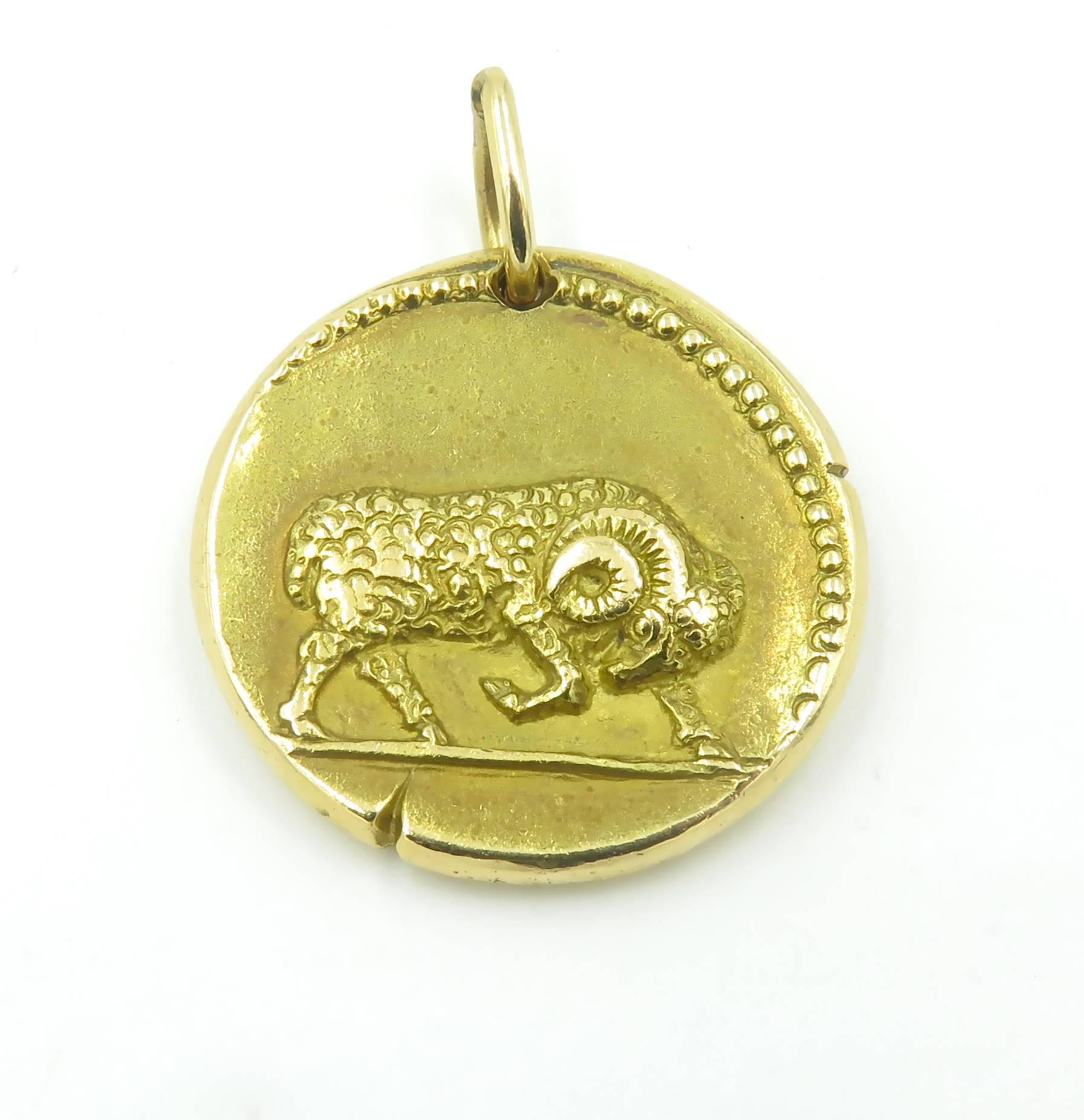 An 18 karat yellow gold zodiac pendant representing the astrological sign for Aries.  Signed Van Cleef and Arpels serial number 16V5162.  Measuring approximately 26.5mm in diameter with an approximate gross weight of 19.2 grams.