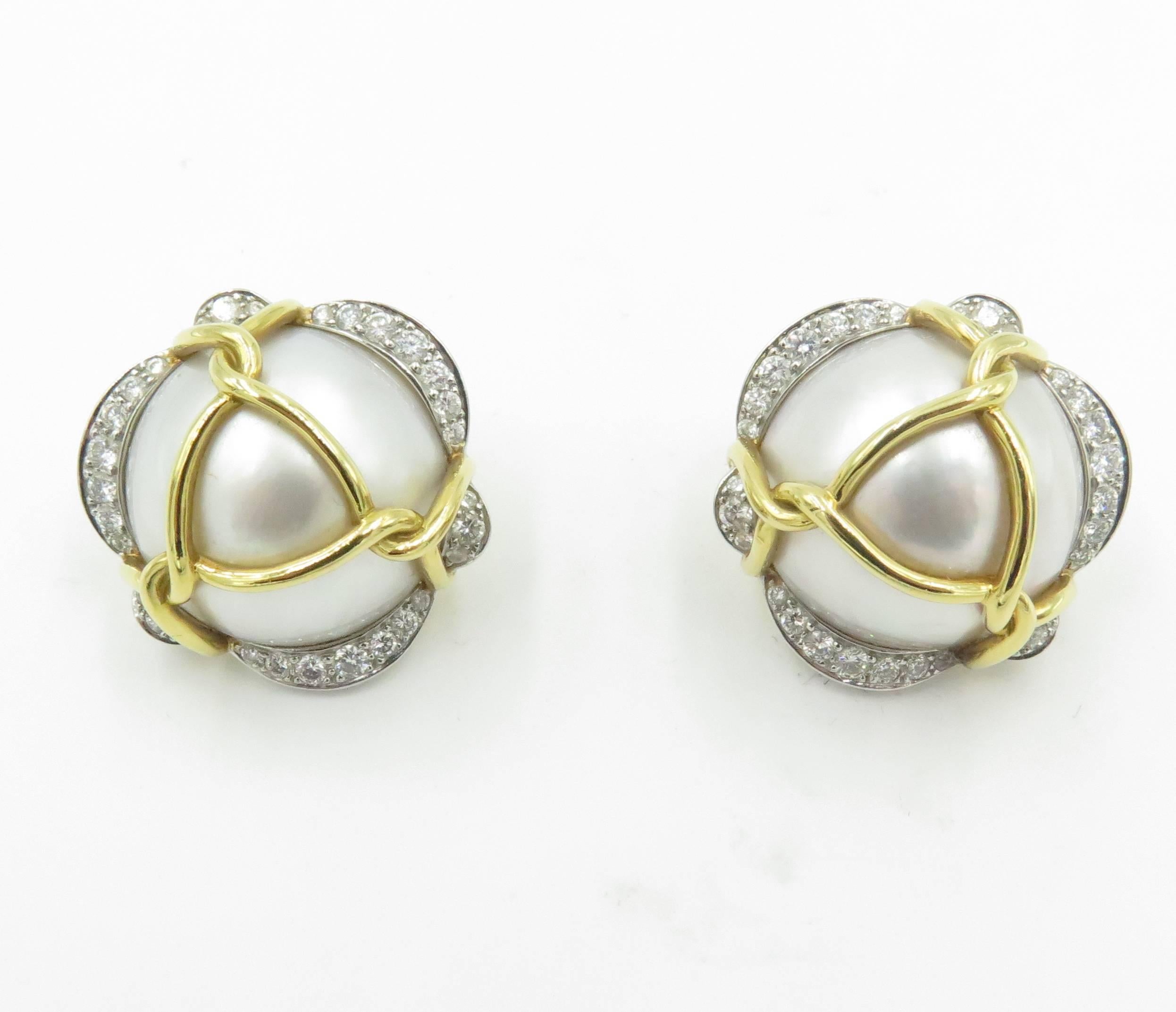 A pair of 18 karat yellow gold, mabe pearl and platinum set diamond earrings.  Verdura.  The earclips center a 17mm white mabé pearl, edged with undulating bands of diamonds set in platinum, and wrapped with polished yellow gold rope. An original