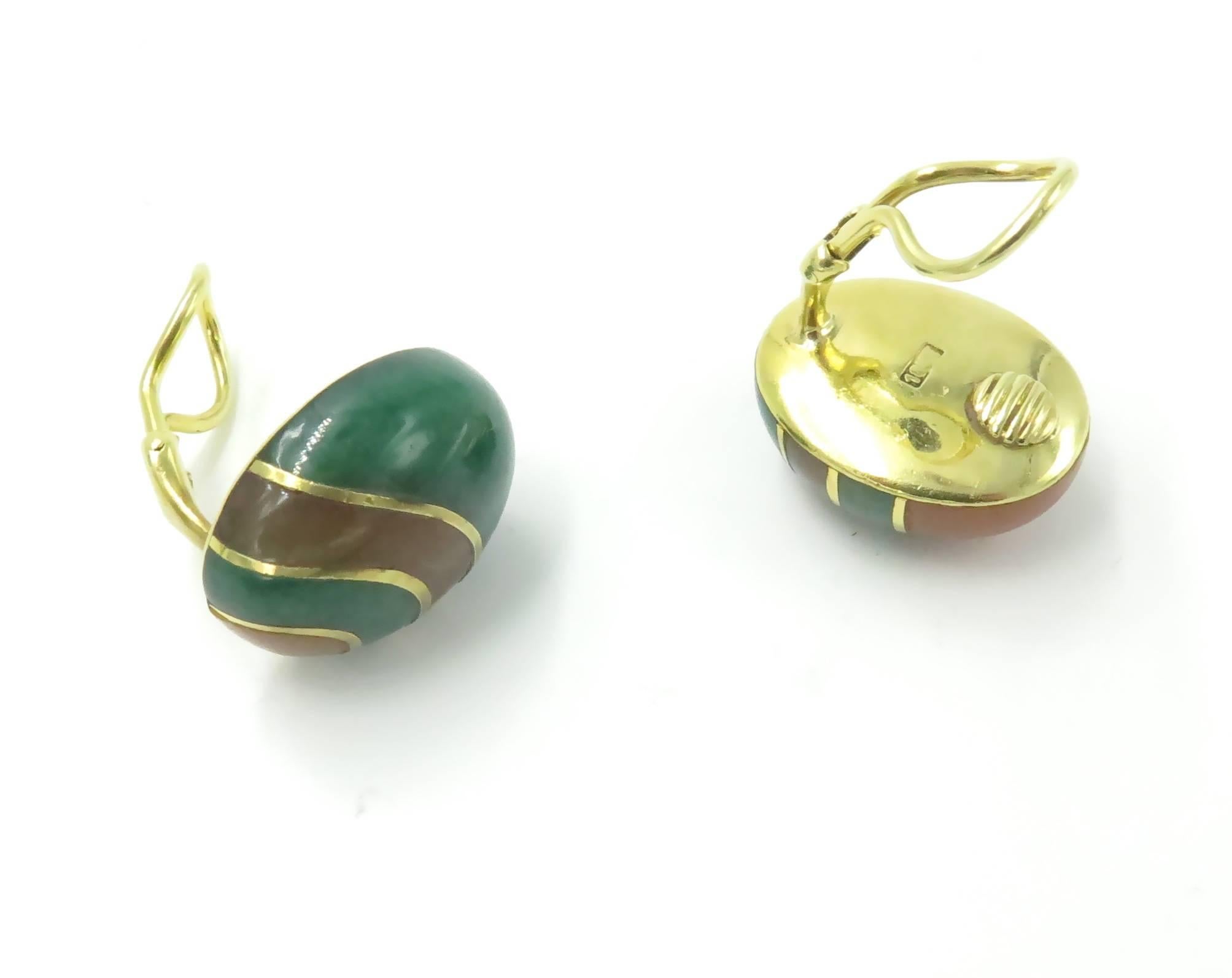A pair of 18 karat yellow gold and hardstone earrings. Angela Cummings for Tiffany & Co. Circa 1980. Of oval outline, set in opposing swirled patterns of green and orange hardstone. Length is 3/4 inches. Gross weight is approximately 19.1 grams.