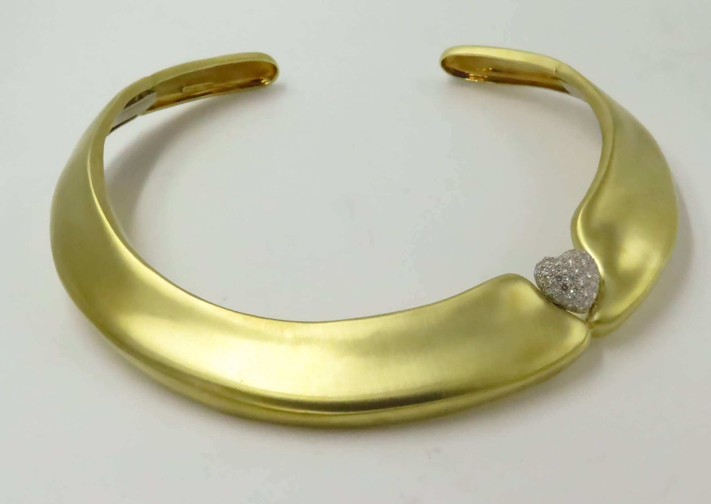 A Marlene Stowe 18 karat yellow gold, platinum and diamond necklace, circa 2000.  Signed M Stowe 18K PLAT.  The acid-finished yellow gold choker is of tapering form from 1/2 inch wide at the back to 7/8 inch wide at the front, with an offset