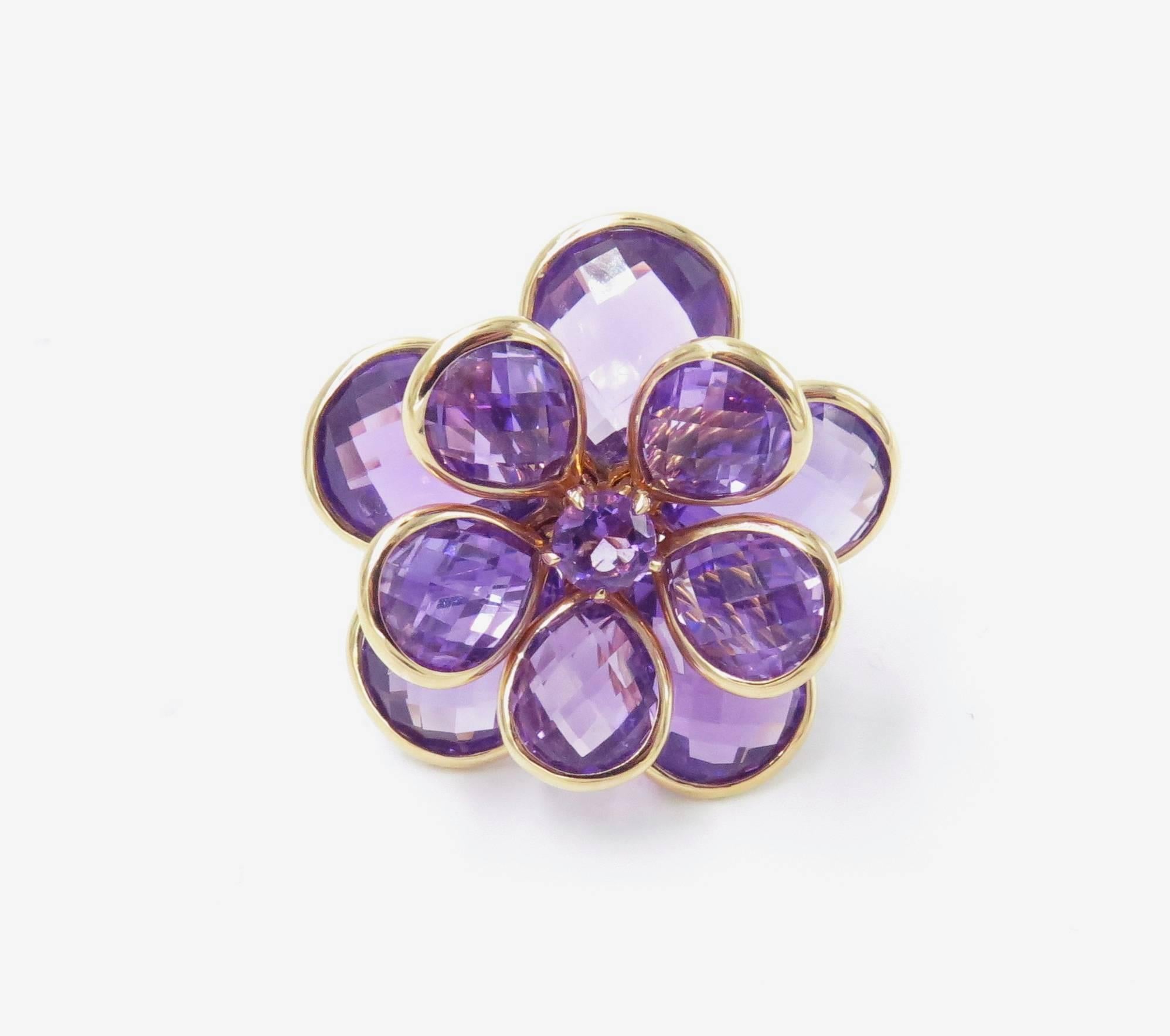 An 18 karat rose gold and amethyst ring, Suarez. Circa 2000. Designed as an articulated flowered, set with amethyst briolette petals, centering a circular-cut amethyst. Size 6 1/2. Gross weight is 21.3 grams. With maker's mark for Suarez. Stamped