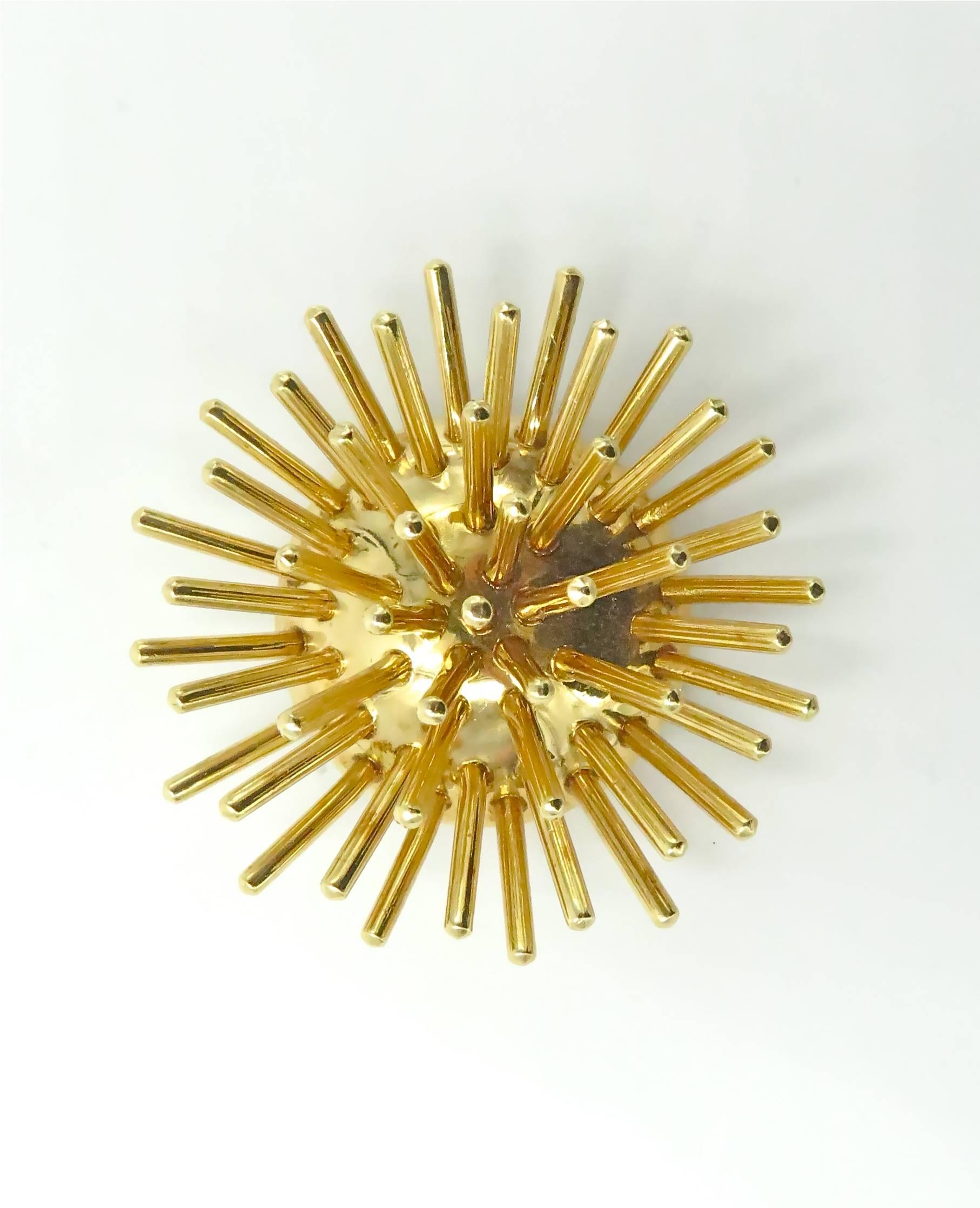 A 14 karat yellow gold Sputnik brooch. Circa 1960.  Cartier.  Gross weight approximately 33.3 grams.