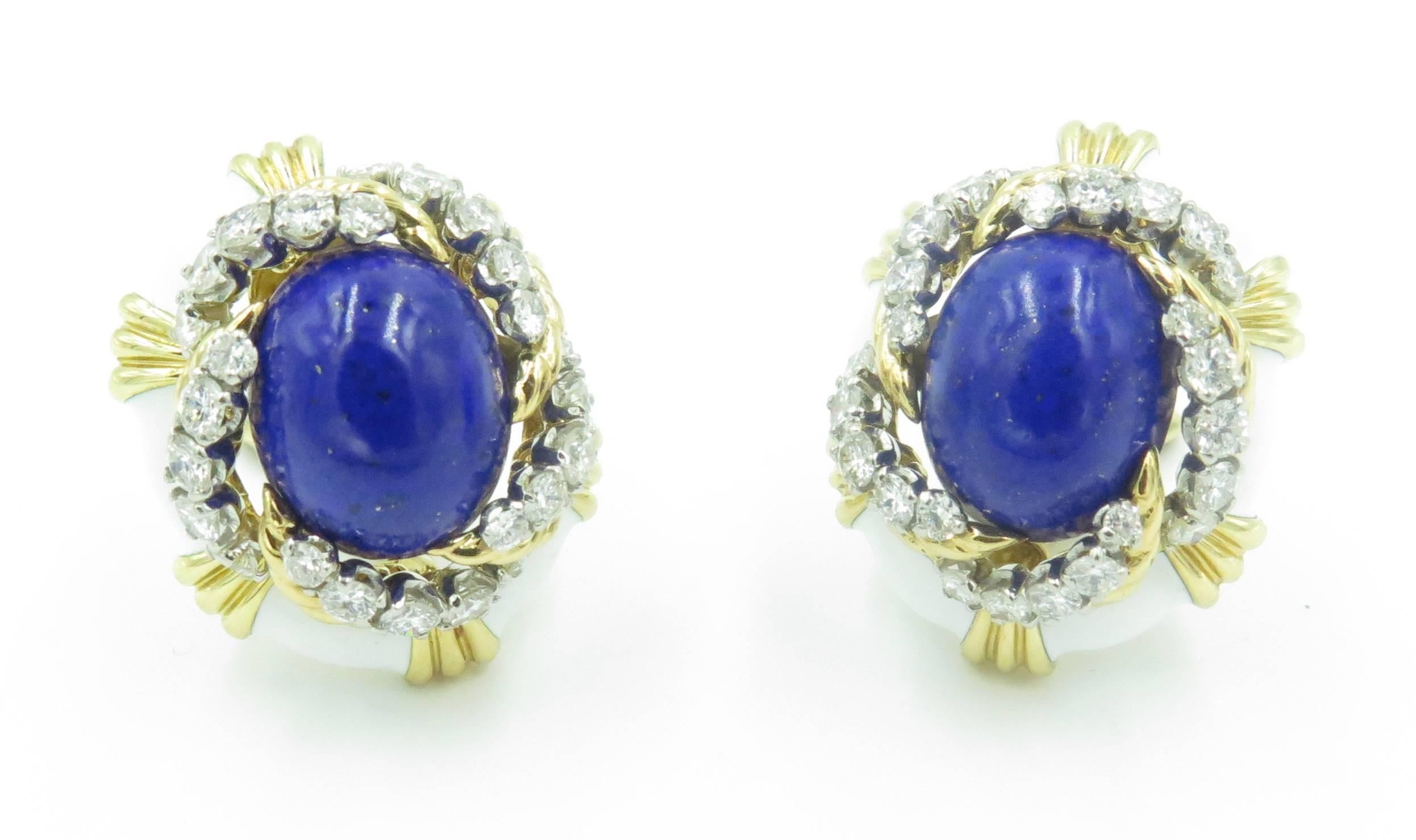 A pair of 18 karat yellow gold, white enamel, lapis lazuli and diamond earrings.  David Webb. Circa 1990. Each designed as a white enamel oval plaque, with fluted gold accents, centering an oval lapis lazuli cabochon, measuring approximately 15.00 x