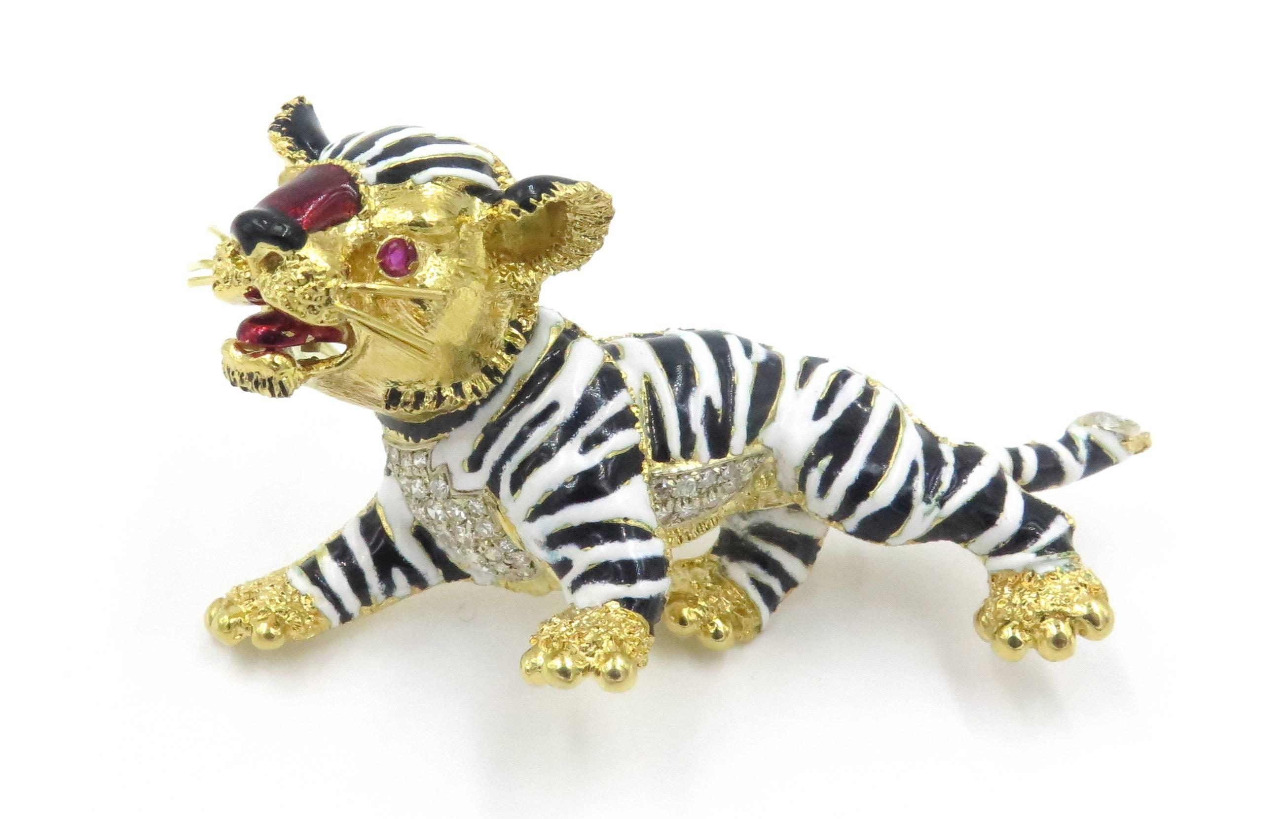 An 18 karat yellow gold, enamel and diamond tiger brooch.  Signed Frascarolo, Italy.  Circa 1970.  Designed as a white and black enamel stylized tiger, with pavé-set diamond accents, enhanced by red enamel nose and tongue, with circular-cut ruby