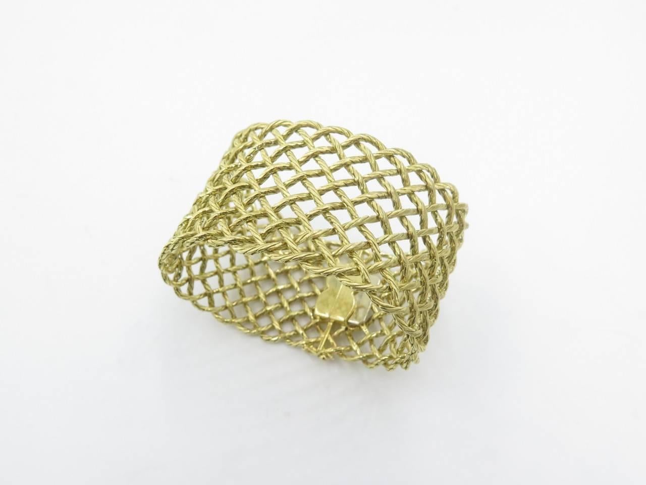 An 18 Karat Yellow Gold Buccellati Gold Crepe de Chine Bracelet.  Circa 1990.  Designed as a flexible openwork matte gold rope work cuff bracelet.  Length is approximately 7 1/4 inches.  Gross weight 69.6 grams.  Stamped Buccellati, Italy. 18K. 
