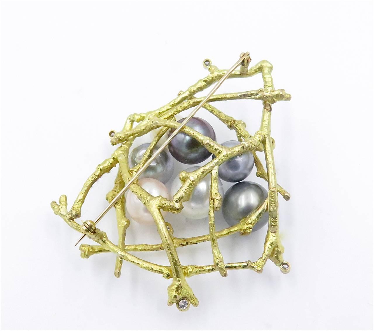 A 14K yellow gold and white South Sea, Tahitian cultured pearl and diamond Twig Nest brooch. Sam Shaw. Circa 1980.  Designed as a textured gold geometric nest, centering white South Sea cultured pearls and gray Tahitian cultured pearls of various