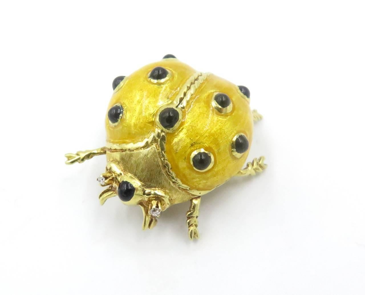 A pair of 18 karat yellow gold, enamel and diamond lady bug brooches.  Circa 1980. Each designed as a green or yellow enamel bug, decorated with black enamel spots, with circular-cut diamond eyes. Length of each is approximately 1 inch. Gross weight