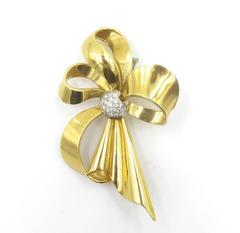 A Gold and Diamond Bow Brooch.