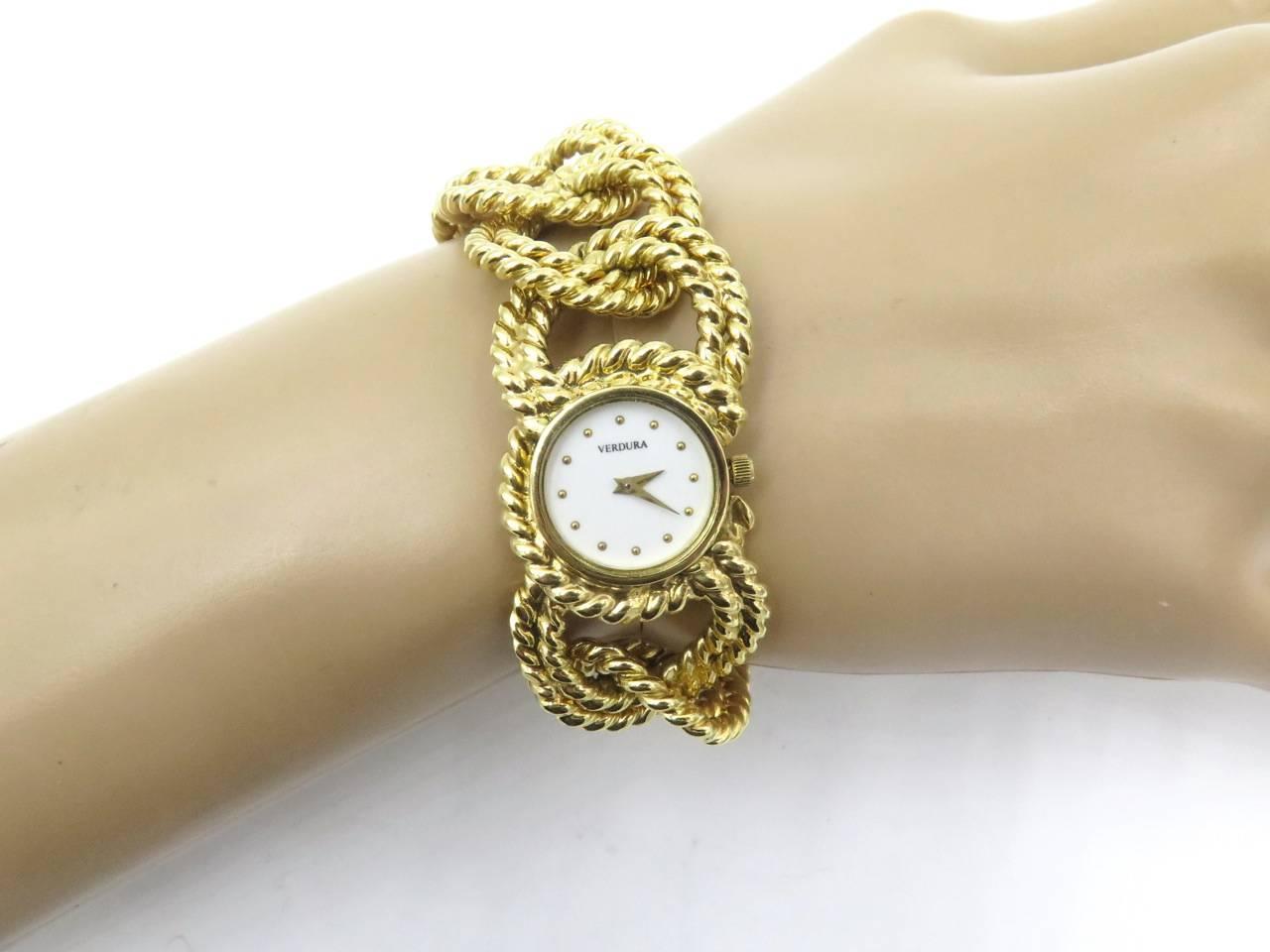 An 18 karat yellow gold rope link bracelet watch, Verdura.  Of quartz movement, the white dial with dot numerals, with rope link bezel, joined by a rope work curb link bracelet. Length is approximately 7 1/2 inches, gross weight is approximately
