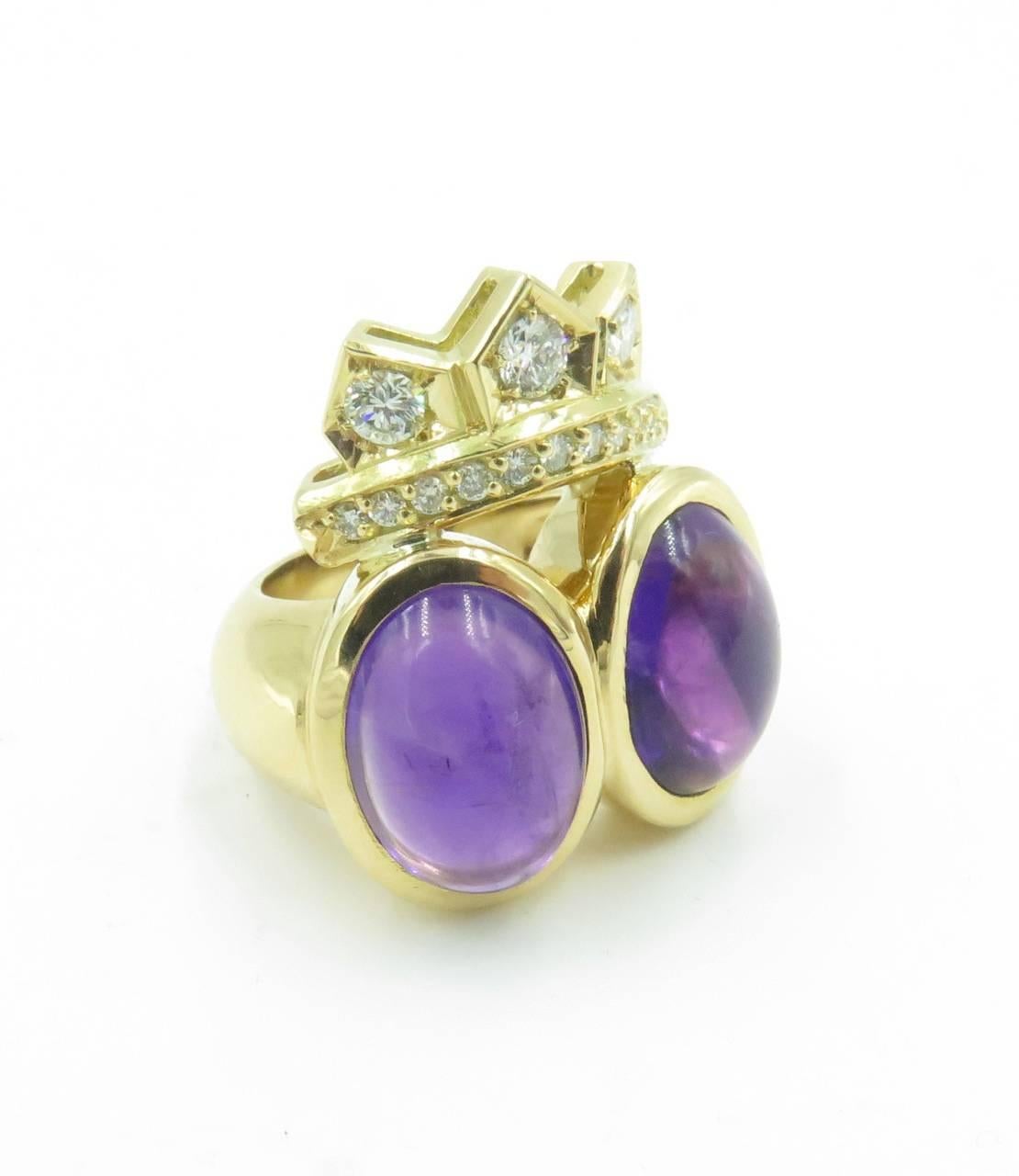An 18 karat yellow gold, amethyst and diamond ring.  Centering two (2) oval amethyst cabochons, weighing approximately 18.35 carats total, enhanced at the top by a crown motif, set with circular-cut diamonds.  Fourteen (14) diamonds weigh