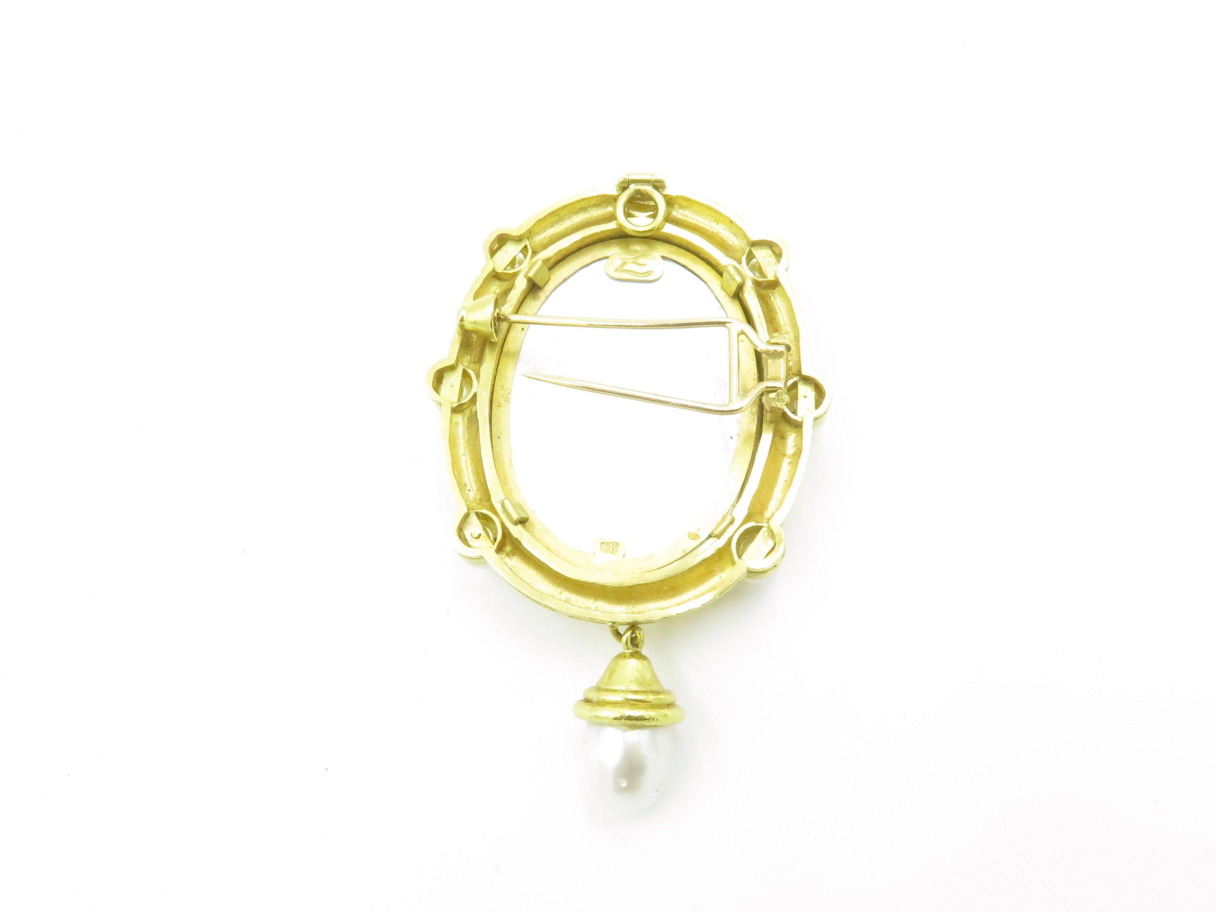 An 18 karat yellow gold, venetian glass, pearl and mother of pearl brooch. Elizabeth Locke. Of oval outline, set with a reverse carved sage green Venetian glass panel, depicting a classical woman, backed by mother of pearl, within a hammered gold