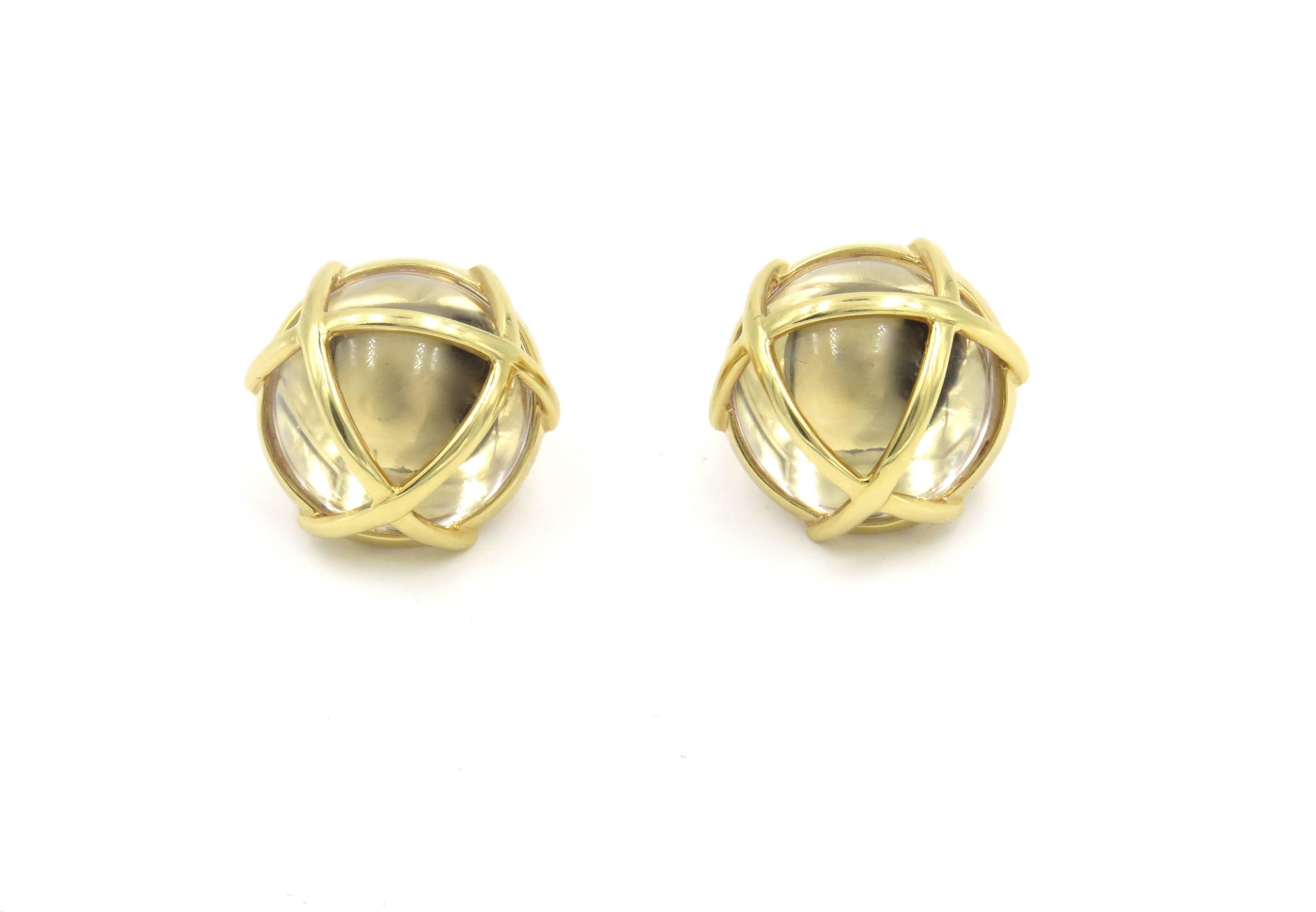A pair of 18 karat yellow gold and rock crystal earrings.  Verdura.  The design is referred to as Caged.  Each designed as a rock crystal dome encased in polished gold cage. Diameter is approximately 3/4  grams.
