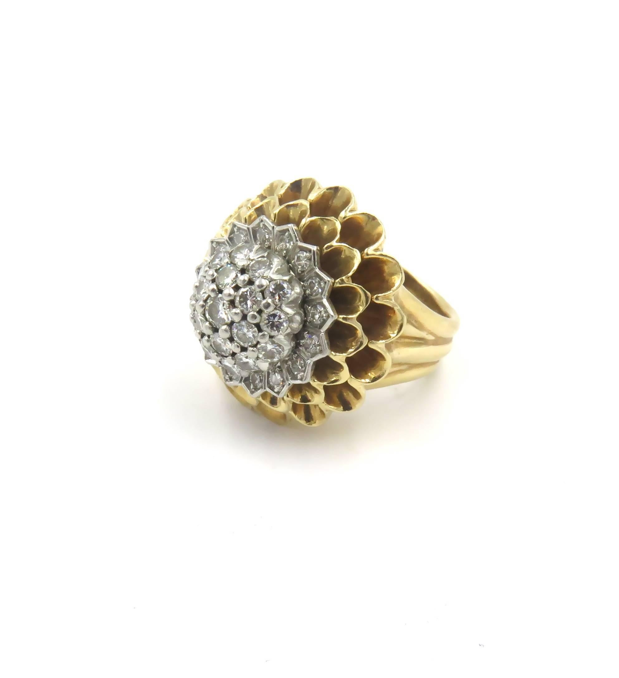 A 14 karat yellow gold and diamond ring.  Tiffany & Co. Circa 1945. Designed as a polished gold chrysanthemum, centering a cluster of circular cut diamonds. Thirty four (34) diamonds weigh approximately 1.40 carats. Size 6. Gross weight is