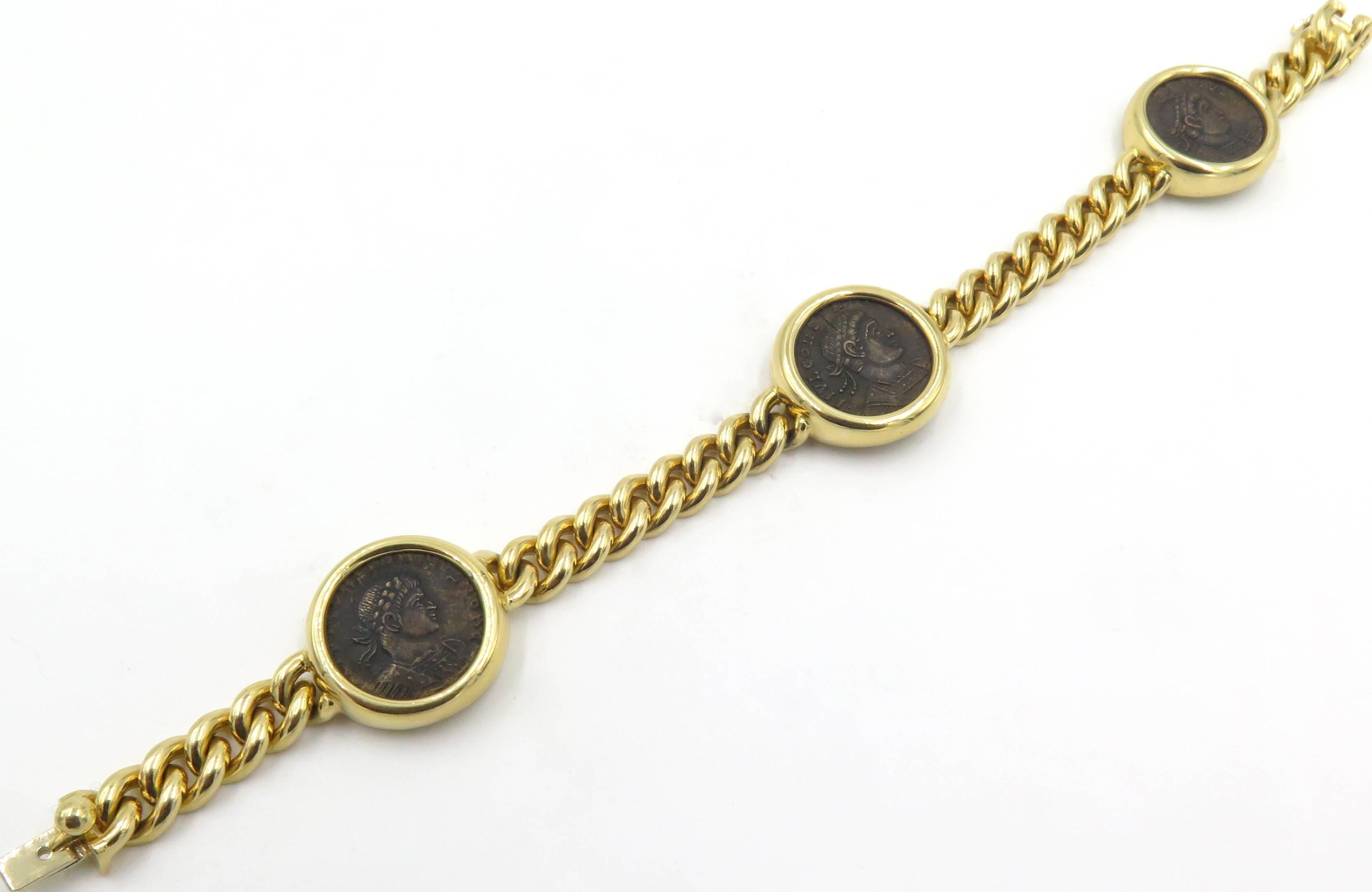 An 18 karat yellow gold and Roman coin bracelet.  Bulgari.  Circa 2000.  The bracelet is designed as (3) three Roman  bronze coins that are bezel set, connected by a solid cable link.  The reverse of the bracelet is engraved TREVERI CONSTANTINUS