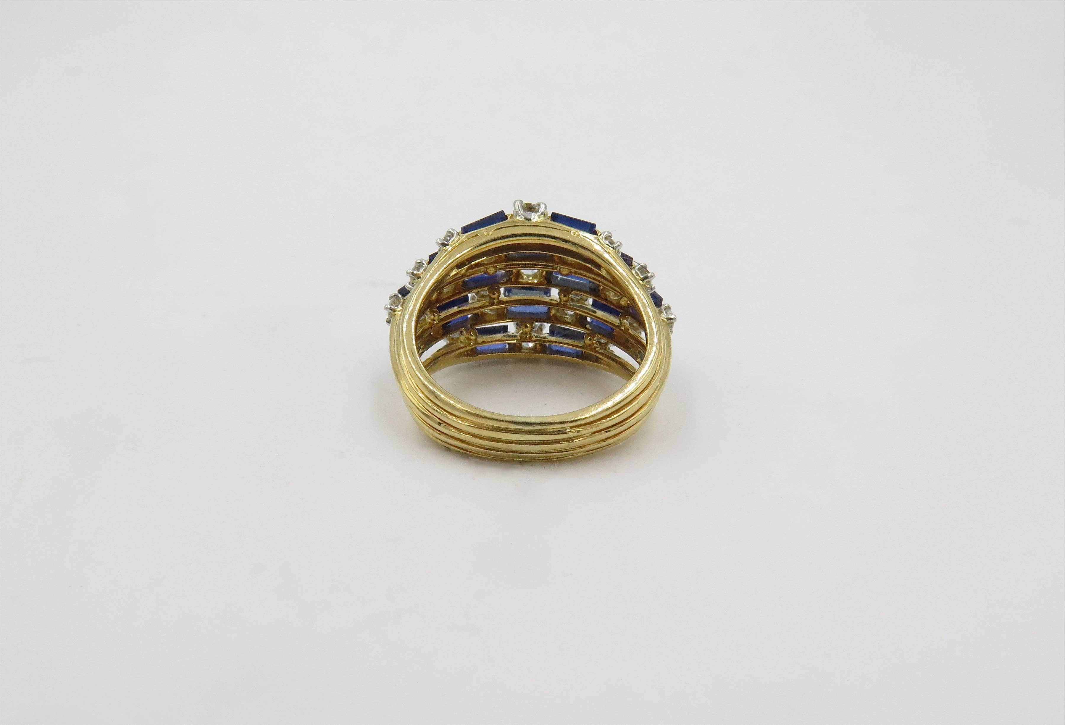 An 18 karat yellow gold, diamond and sapphire ring. Oscar Heyman Brothers. Of openwork bombe design, set with circular cut diamonds and baguette cut sapphires set in a brick work pattern. Nineteen (19) diamonds weigh approximately 1.60 carats,