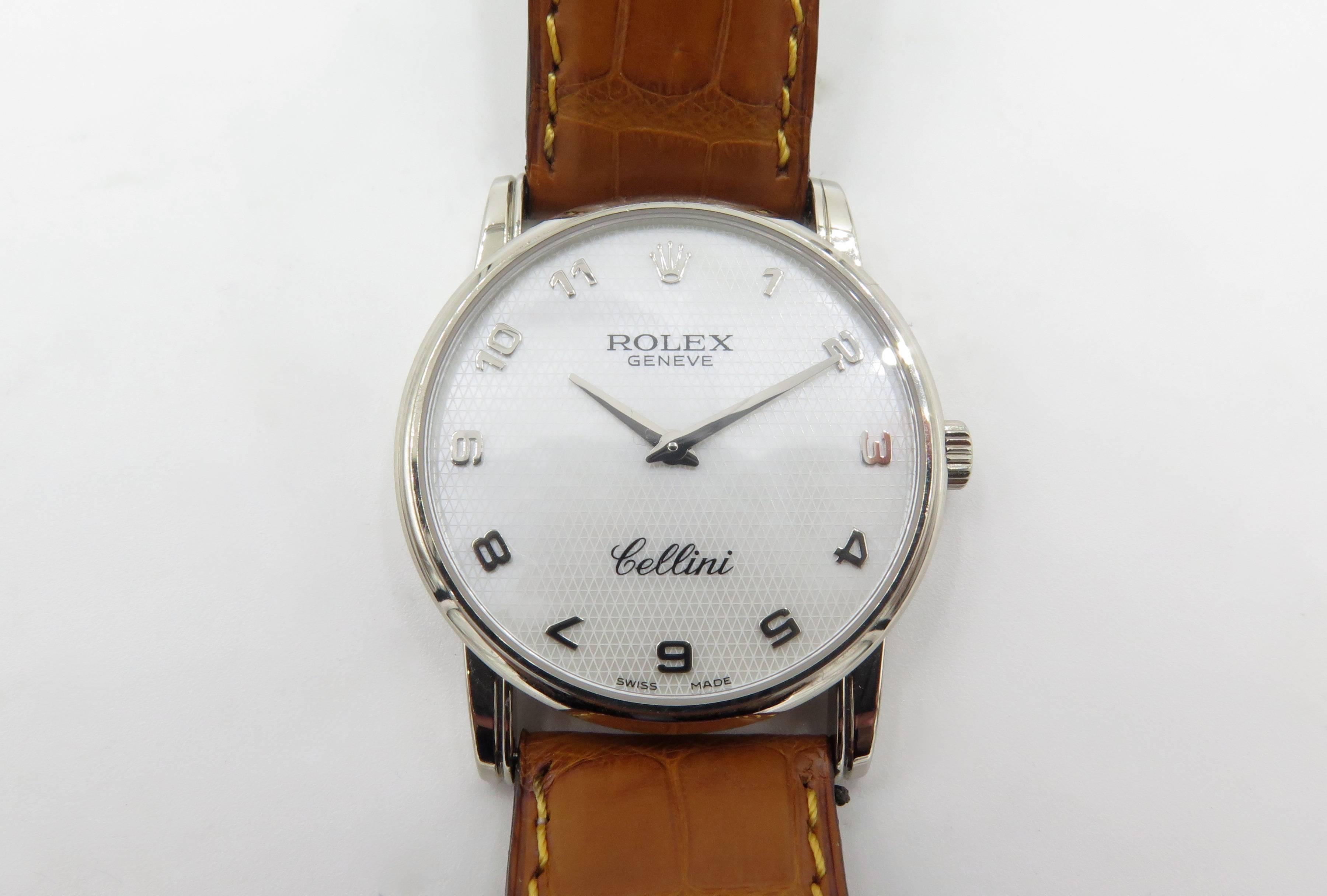 An 18 karat white gold Cellini watch. Rolex. Geneve. Of manual winding movement, the white mother of pearl dial of circular outline, with Arabic numerals, joined by a brown leather strap. Signed Rolex Geneve, case back numbered 5116 M760079.