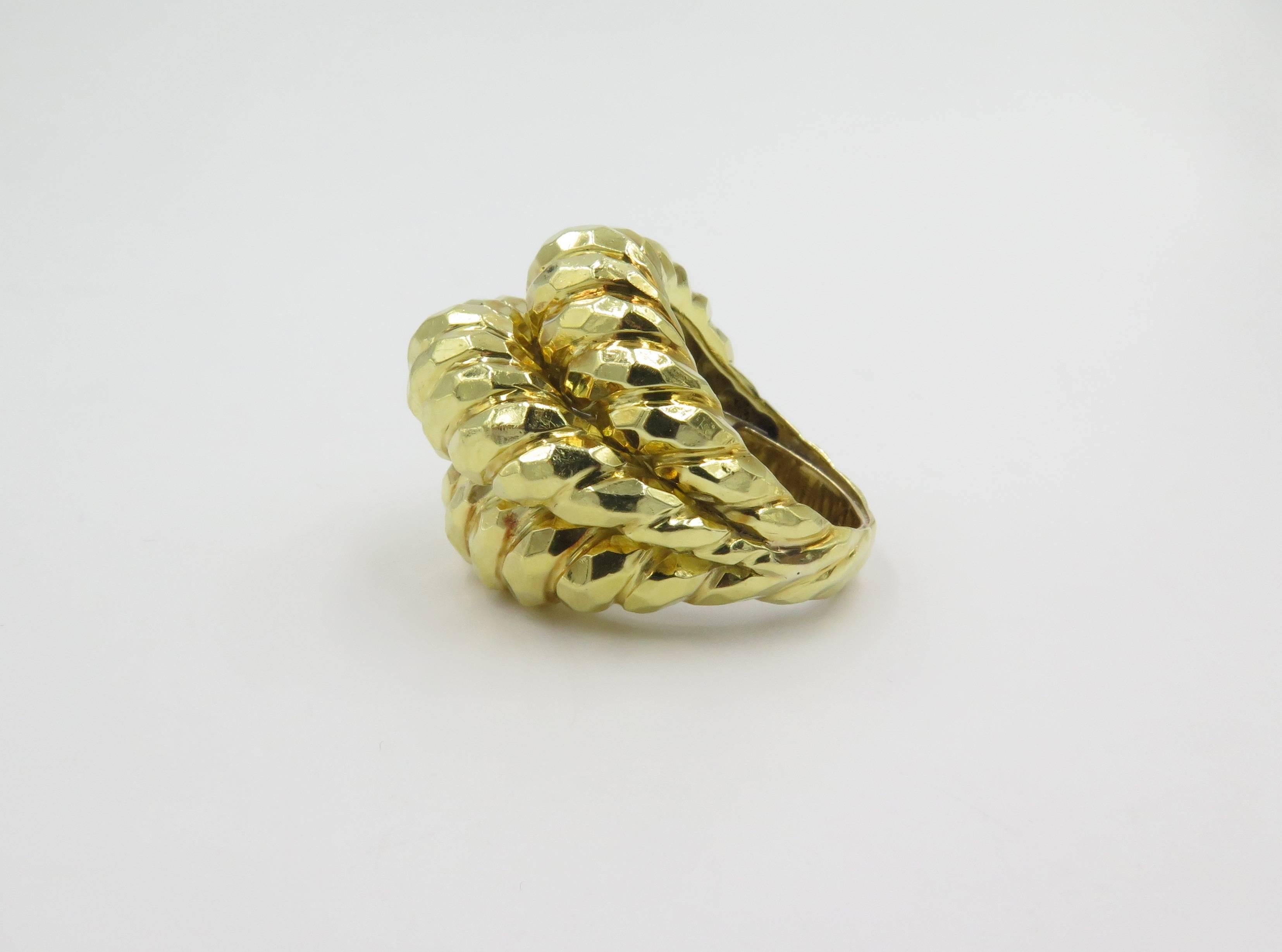 An 18 karat yellow gold ring. Henry Dunay. Designed as a fluted and hammered bombe dome. Size 7 1/2 with sizer. Gross weight is approximately 24.7 grams. 