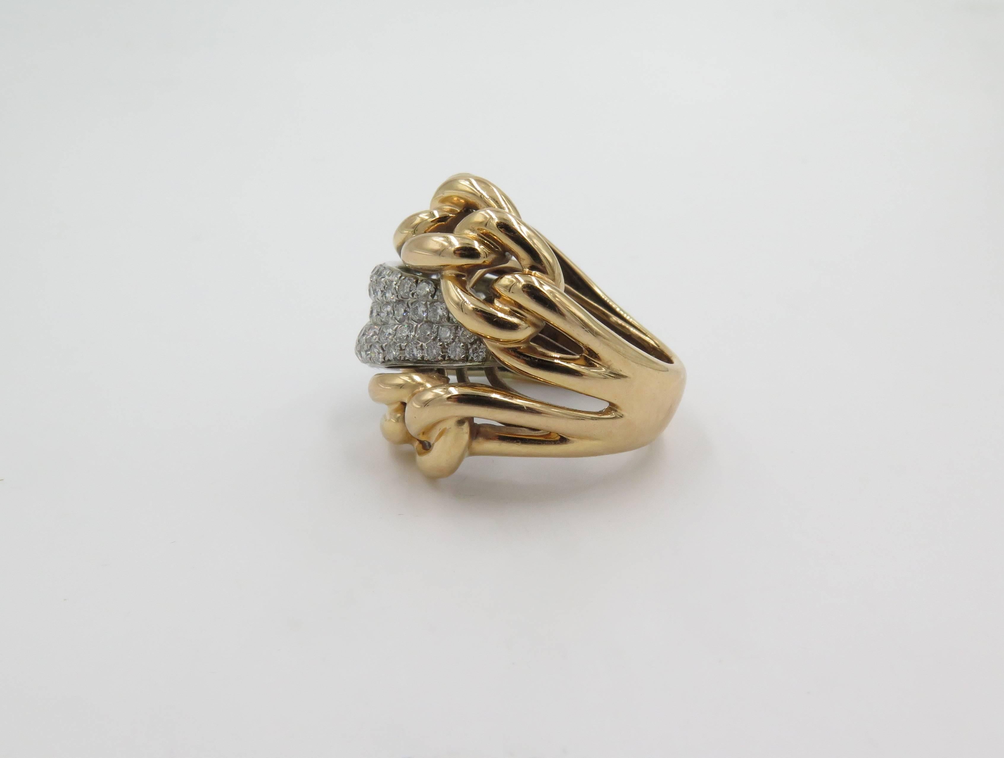 An 18 karat rose gold and diamond ring. Italian. Designed as two polished gold chain link bands, spaced by a pave set diamond scrolling panel. One hundred  diamonds weigh approximately 2.00 carats. Size 8 1/2. Gross weight is approximately 12.4