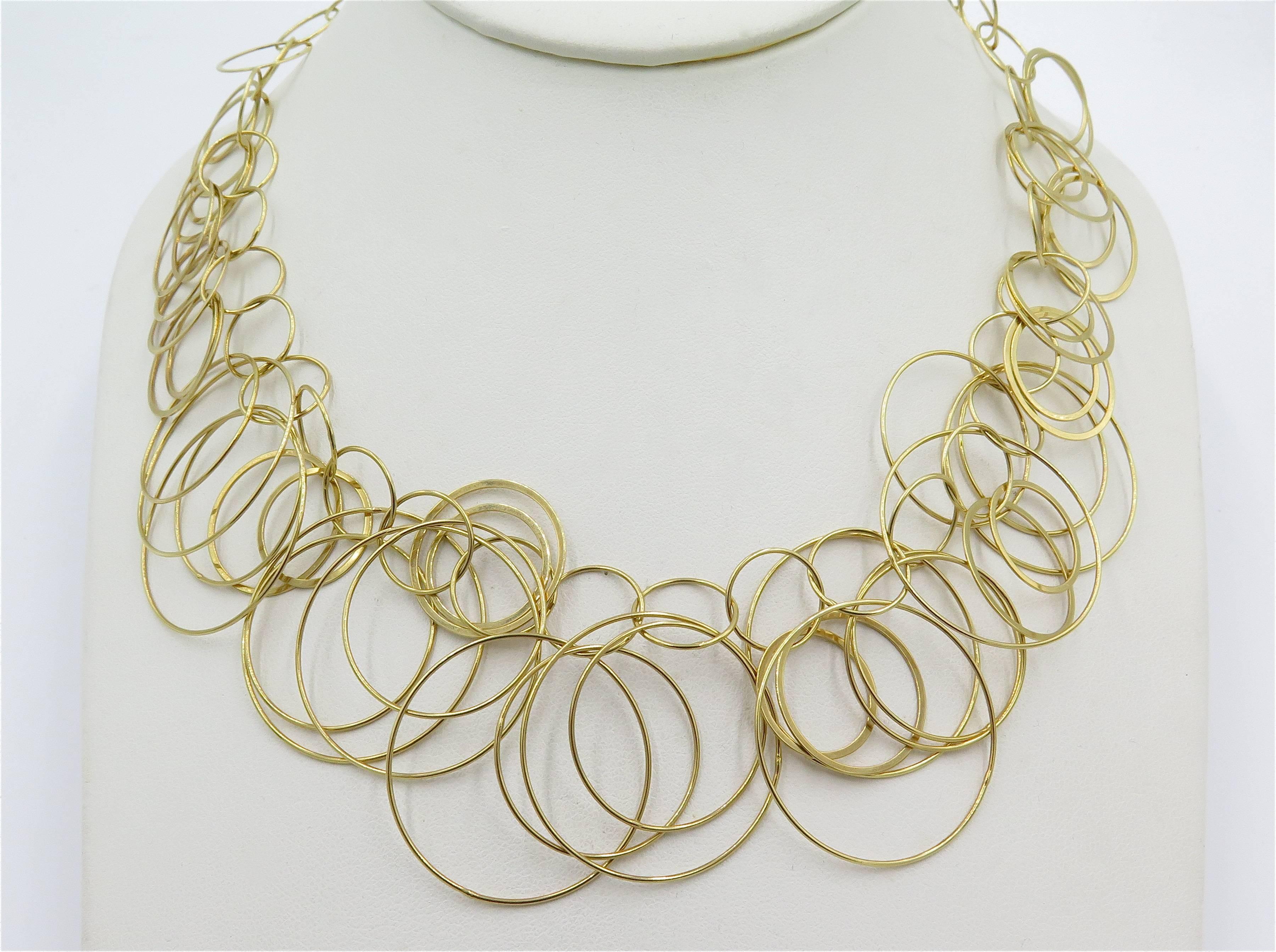 An 18 kararat yellow gold necklace. Carolina Bucci. Italian. Designed as a graduated bib composed of interlocking polished gold rings. With Italian maker’s mark. Unsigned, attributed to Carolina Bucci. Length is approximately 16 inches. Gross weight